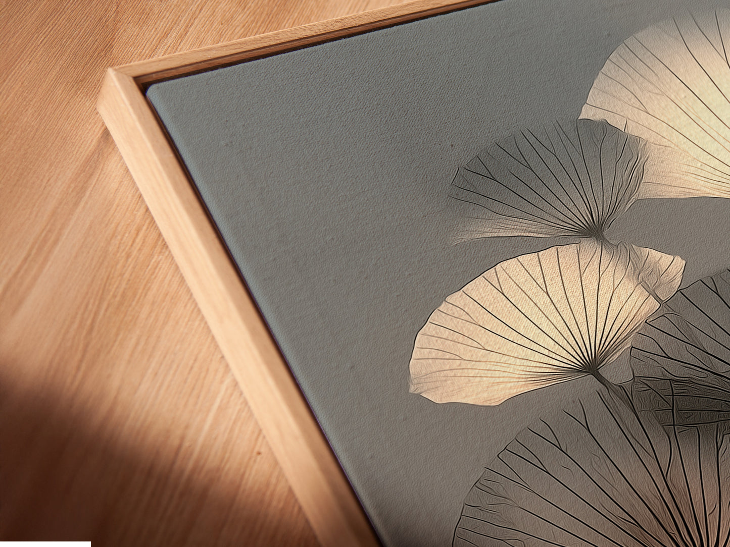 A close-up angled view shows a canvas print in a floating frame. This artwork is a botanical canvas print. The abstract floral design adds a modern touch. This plant artwork enhances bedroom wall decor. The frame gives a gallery feel.