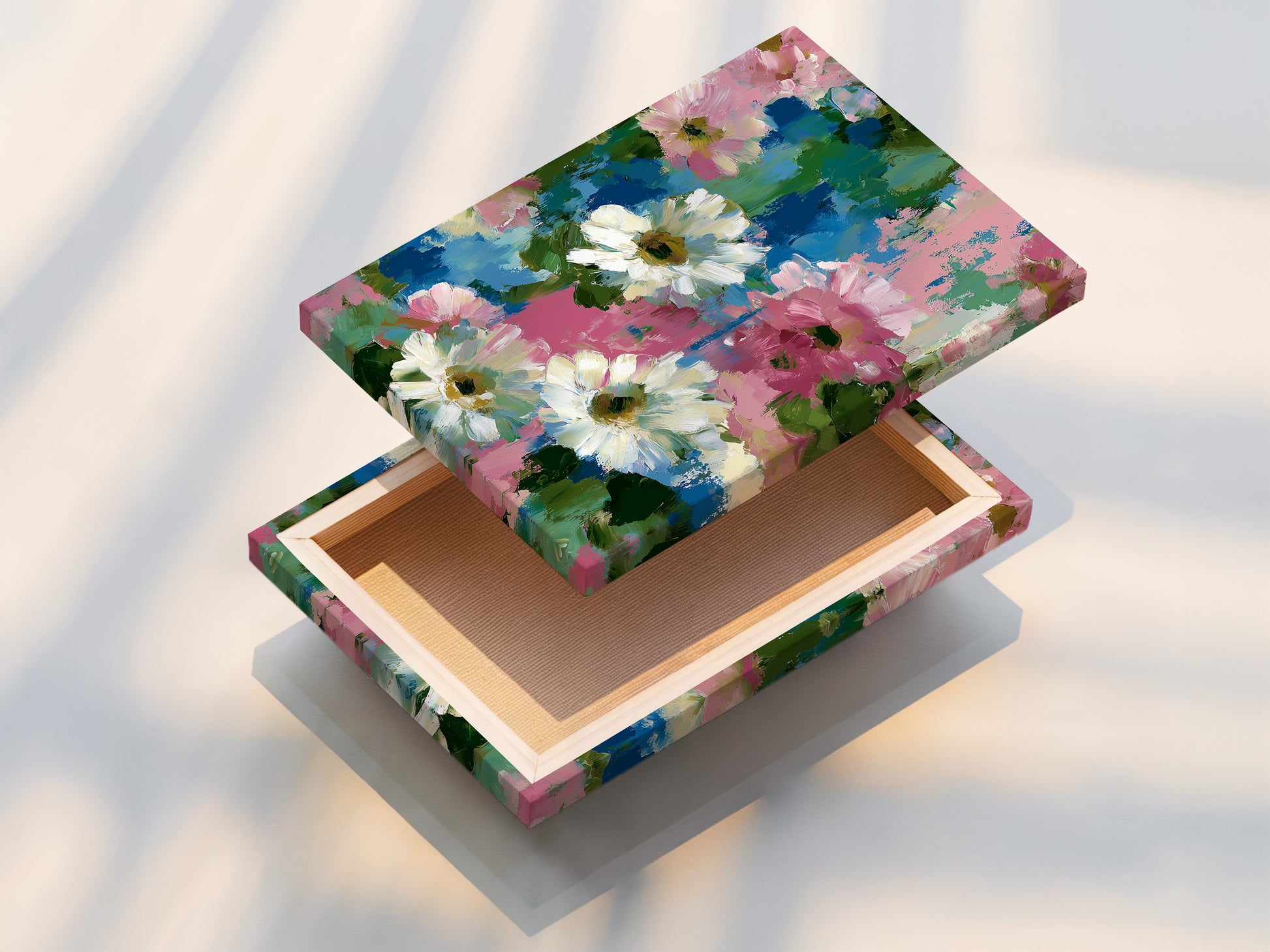 A stretched floral canvas print showcasing pink and blue flower wall art. This impressionist botanical artwork is perfect for bedroom decor. Ideal for homeowners and apartment dwellers. This daisy art print adds a cottagecore touch. Bring spring wall art into your home. Abstract flowers create visual interest. Garden art print for a charming aesthetic.