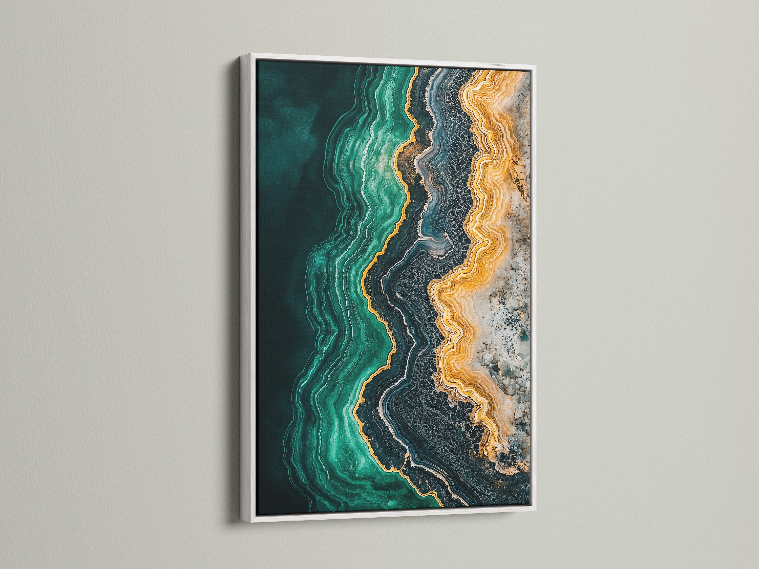 An elegant abstract ocean art print. Emerald green teal and gold tones create a soothing fluid artwork. A white frame adds a touch of sophistication to this contemporary artwork. Elevate your living space with this geode art print.