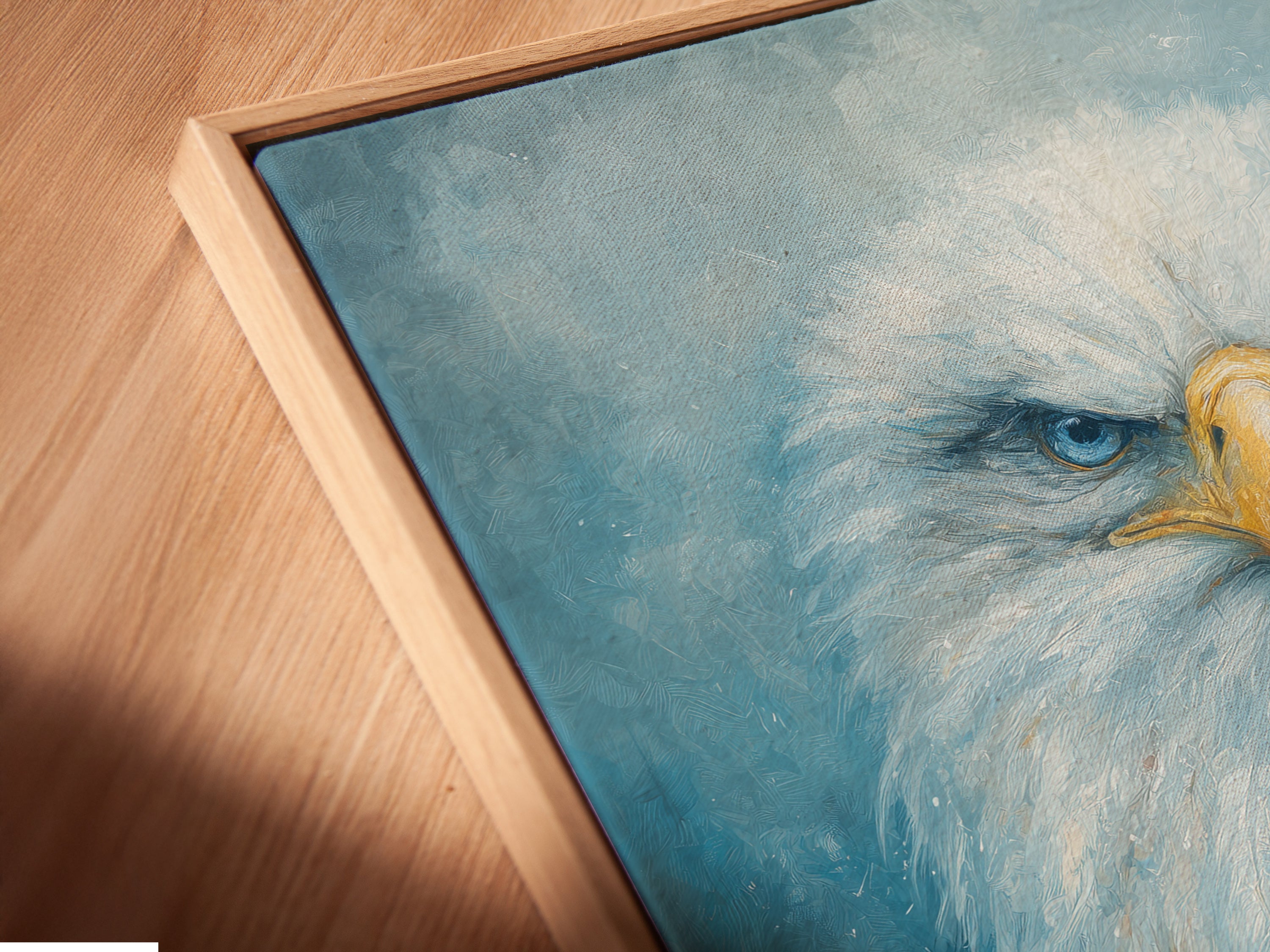 A close-up captures a canvas print of the eagle in a floating frame. The majestic bird's intense gaze is highlighted. This elegant framing style enhances the artwork. It's perfect for modern interiors in homes and offices. The wildlife art complements minimalist styles.