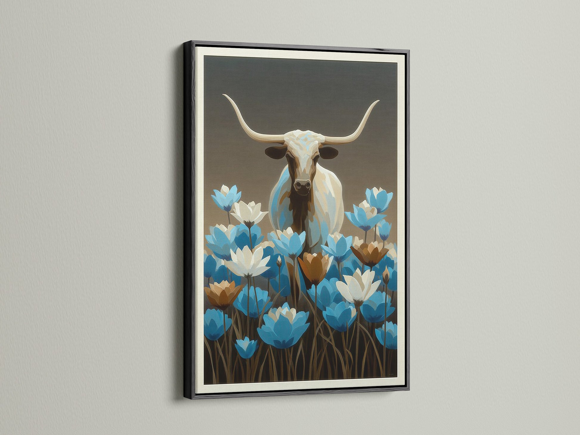 Longhorn bull artwork with blue wildflowers. The frame is black. Western wall decor is perfect for any room. This bull canvas print is ideal for modern farmhouse decor. This blue floral art piece is perfect for your home.