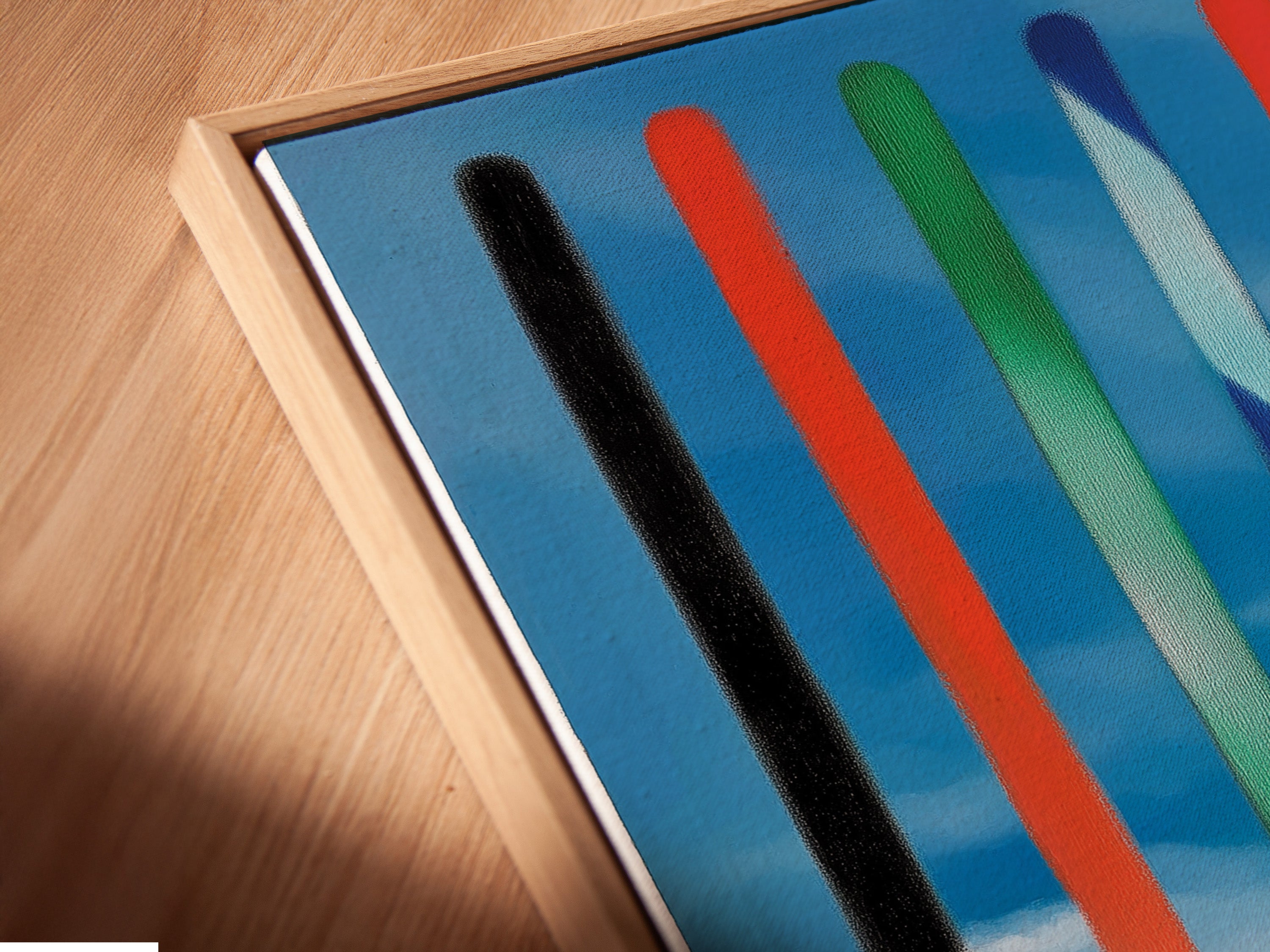 A close-up angled shot shows a canvas print in a floating frame. The floating frame creates a modern and sophisticated look. It gives the illusion that the artwork is suspended. This enhances the artwork's visual impact. Discover the elegance of floating frames.