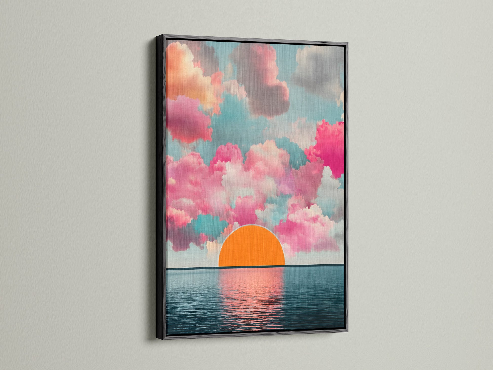 The Sunset Clouds artwork is displayed in a black frame. This modern artwork features pink clouds and a calming horizon print. The seascape canvas is perfect for living room wall art. Add a touch of sunrise art to your home decor.