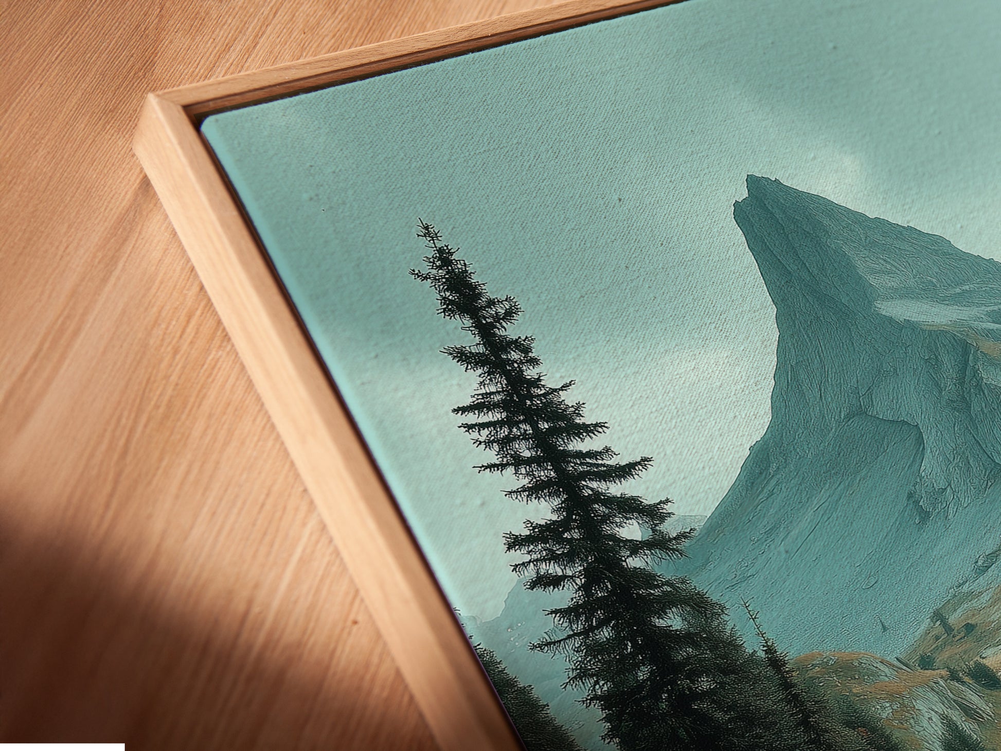 Angled close up of a canvas print in a floating frame. It features mountain landscape artwork showcasing an alpine valley. The floating frame adds a modern touch to the nature print. Perfect for creating a unique display of earth tone wall art.