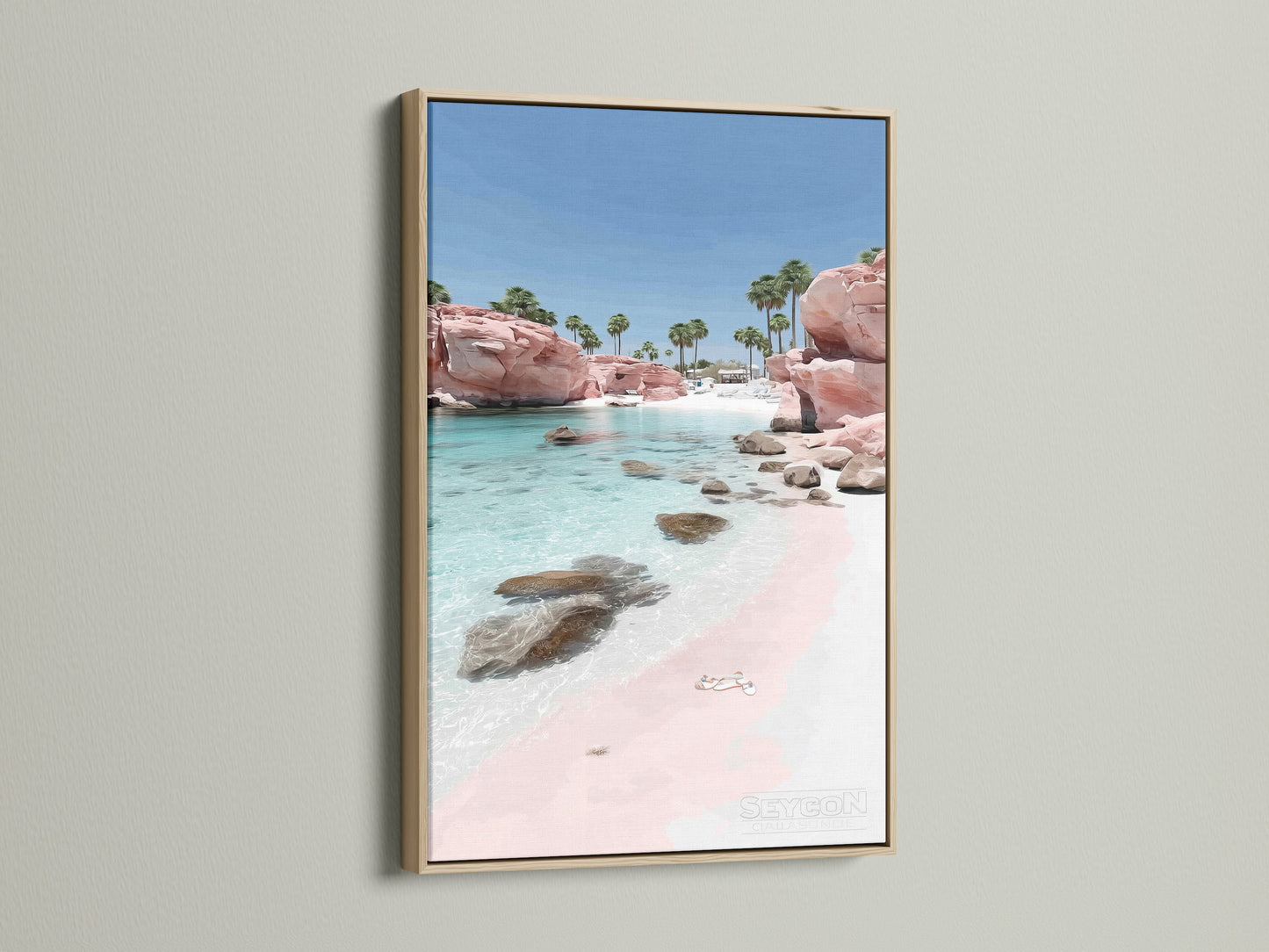 Pink Sand Beach artwork with an oak frame. The coastal print brings a tranquil beachy vibe. Clear turquoise waters wash upon the pink sand. An oak frame enhances this ocean wall art.