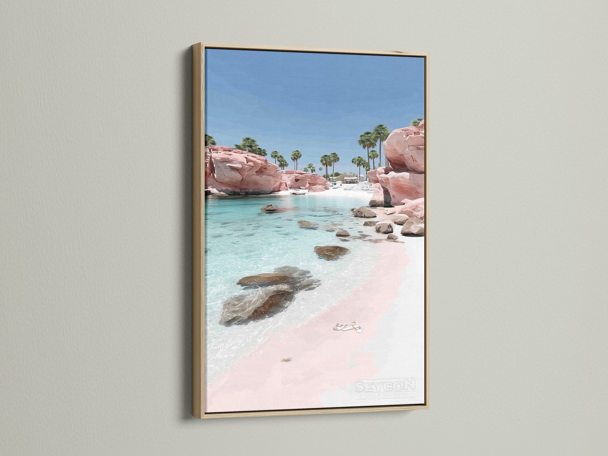Pink Sand Beach artwork with an oak frame. The coastal print brings a tranquil beachy vibe. Clear turquoise waters wash upon the pink sand. An oak frame enhances this ocean wall art.