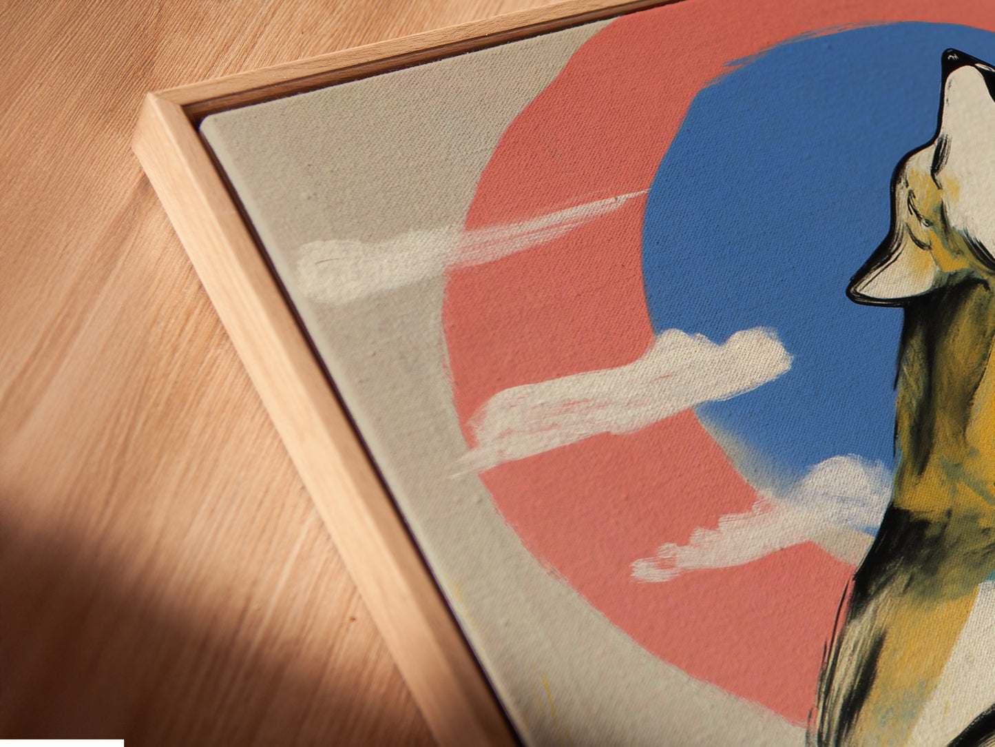 An angled close-up shows a canvas print of a wolf artwork. It is set in a floating frame. The howling wolf is against a modern abstract coral blue sky. This presentation adds depth and style. Perfect for contemporary spaces. It is ready to hang in your home or cabin.