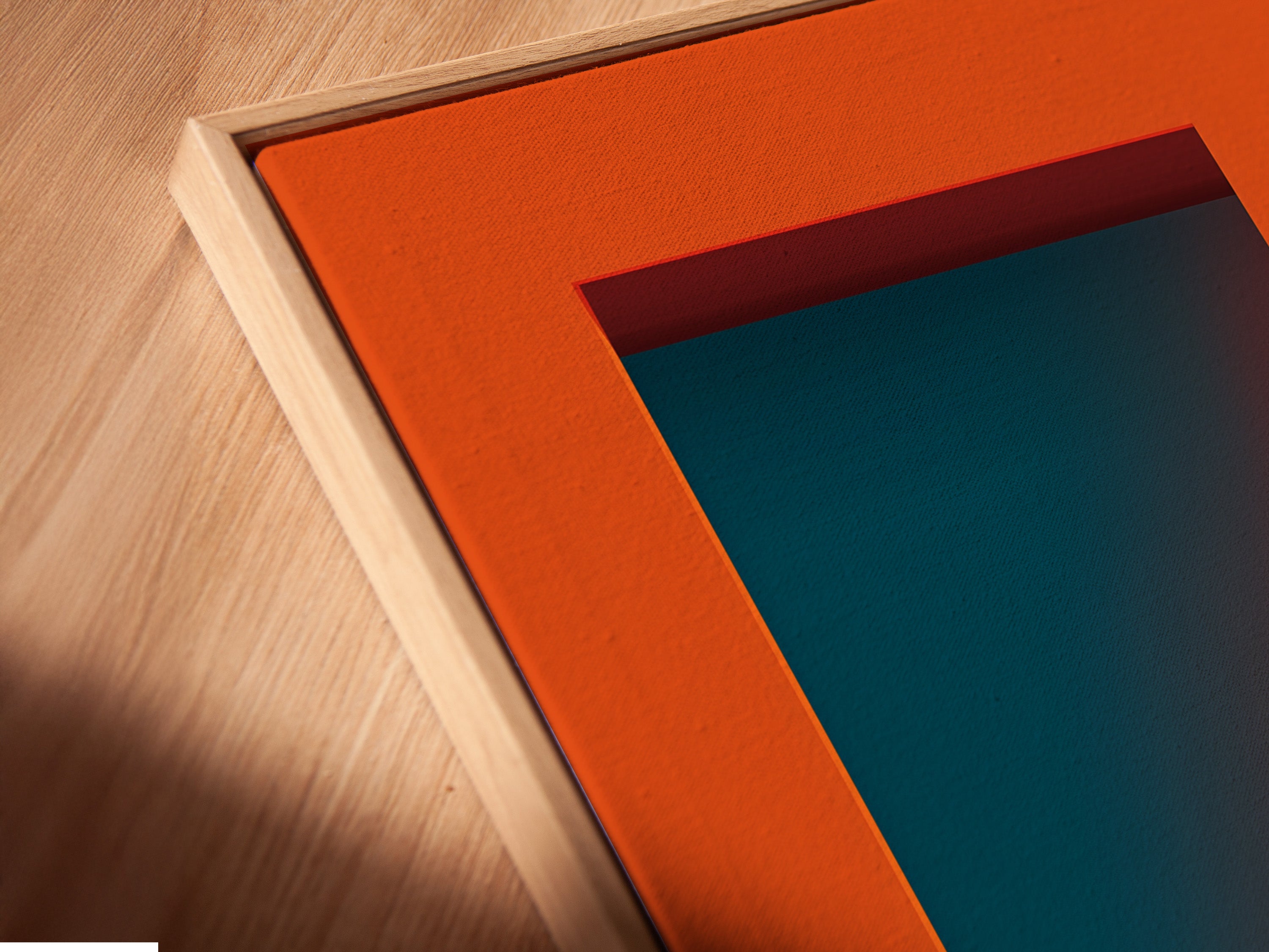 A close-up of a canvas print in a floating frame. The frame enhances the artwork. It's a Western Cowboy scene with orange and teal colors. This retro desert art is perfect for any style of home decor.