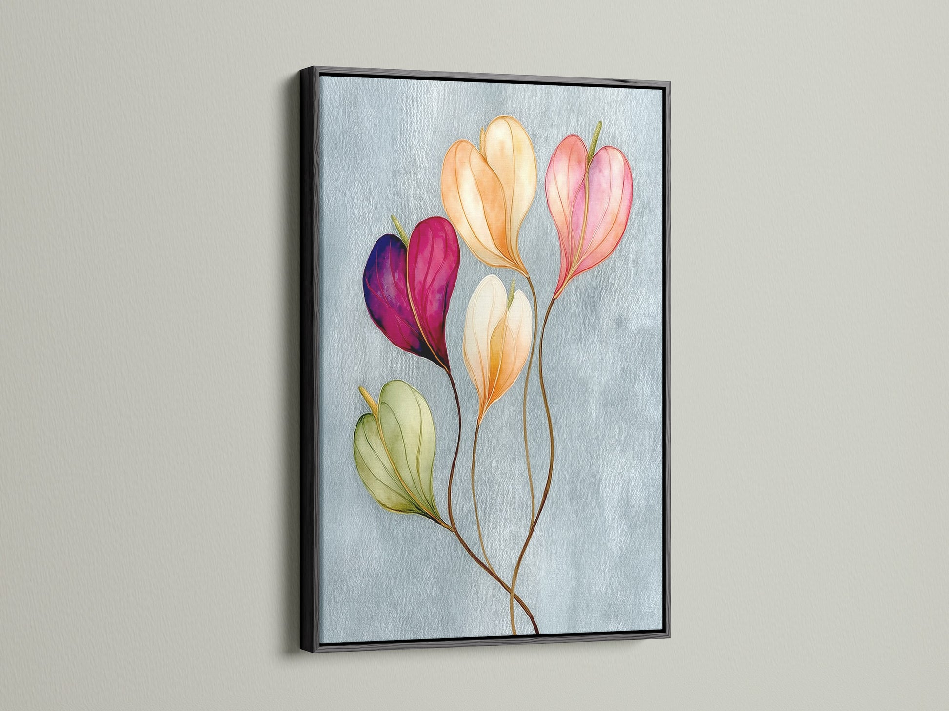 Floral watercolor canvas print in a black frame is displayed. This pastel flower art is a sophisticated touch for any room. The flower artwork brings a modern aesthetic to bedroom wall decor. It is perfect for those who love decorating with floral themes.
