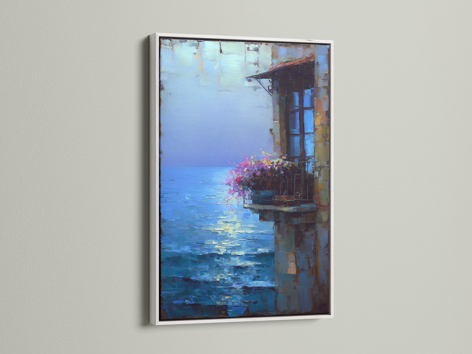 Here is a white frame that enhances the Mediterranean artwork. The coastal wall art adds a fresh touch to any room. Consider this village painting for refined seaside decor.