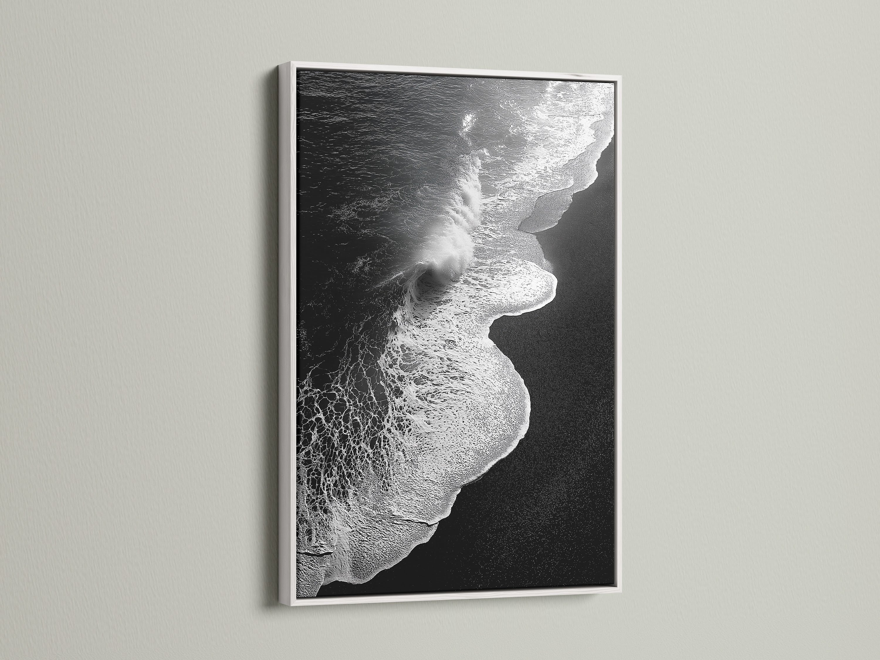 This artwork is a black and white ocean wave print. It is framed in white. It provides a clean and minimalist aesthetic. This beach canvas print brings coastal charm. It's perfect for creating a serene atmosphere. Ideal for bedroom decor and coastal retreats. Explore ocean photography with this stunning piece.