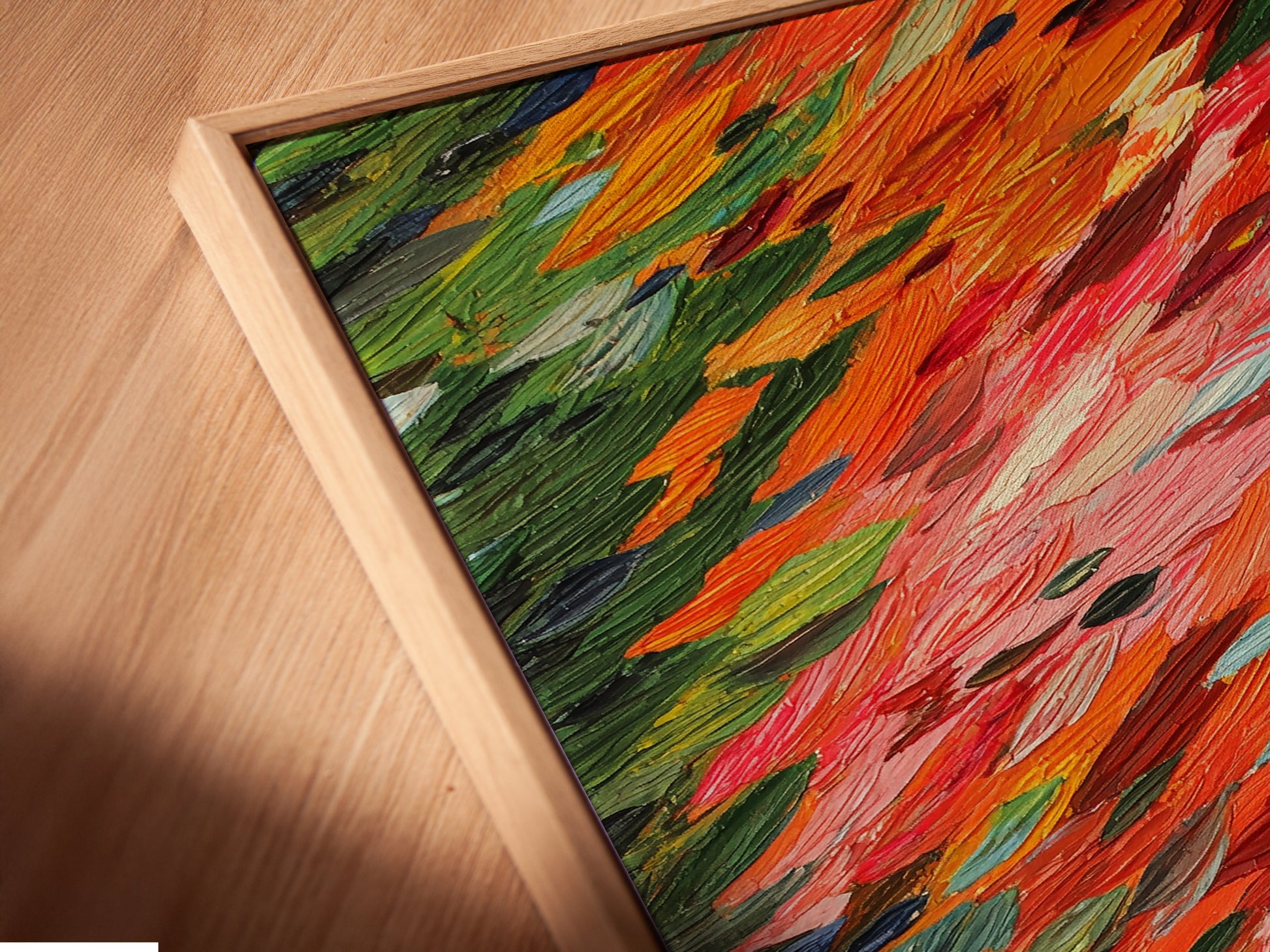 A close-up angled view of a canvas print in a floating frame. The abstract brushstrokes of orange and red create a dynamic and modern look. This artwork enhances contemporary spaces with its vibrant and expressive style making it ideal for modern wall decor.