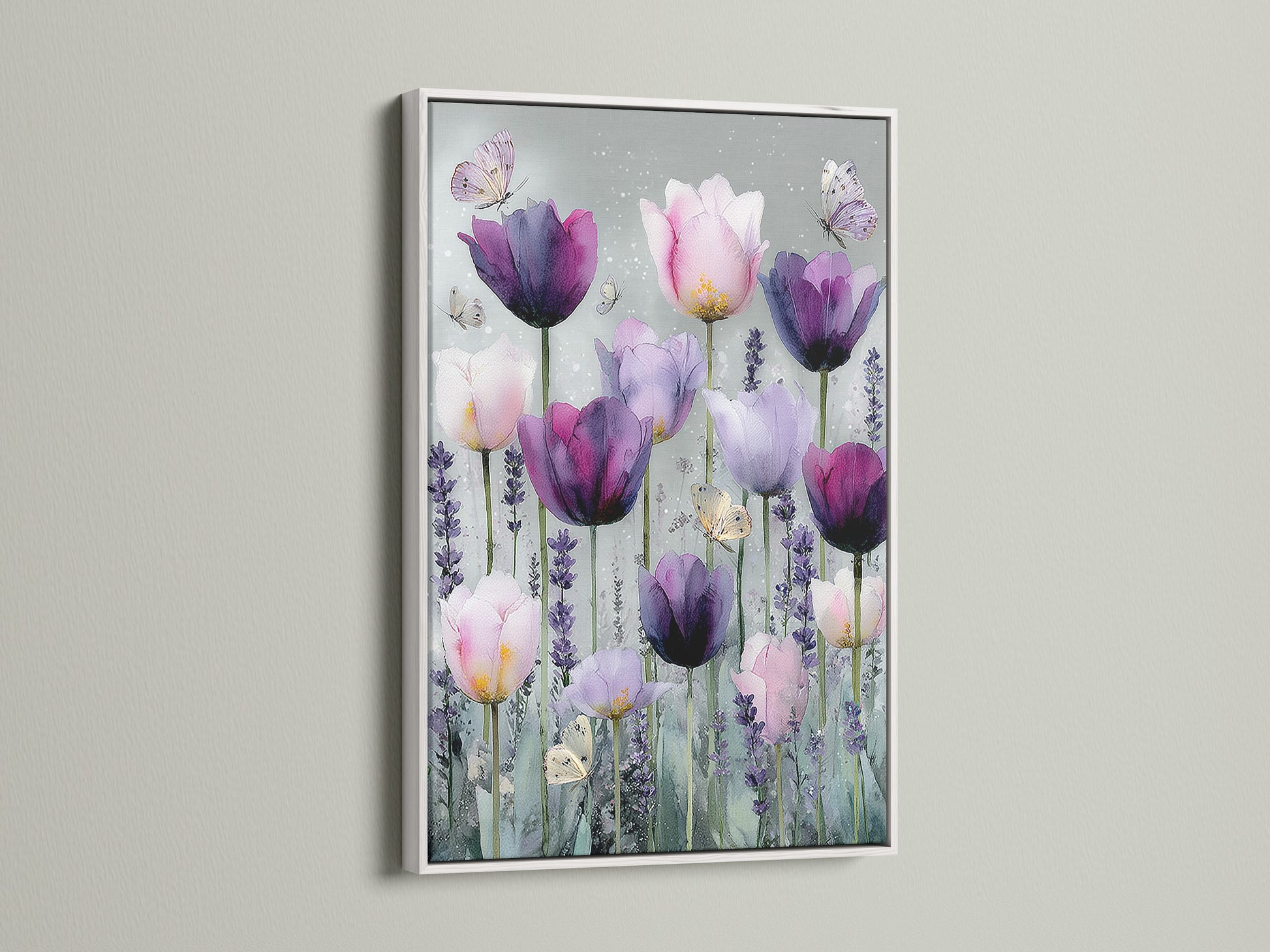 Artwork with a white frame. This artwork showcases a variety of tulips in pink and purple. Butterflies flutter around the flowers adding a touch of nature. The white frame offers a clean modern look. The artwork is displayed on a light wall enhancing its visual appeal.