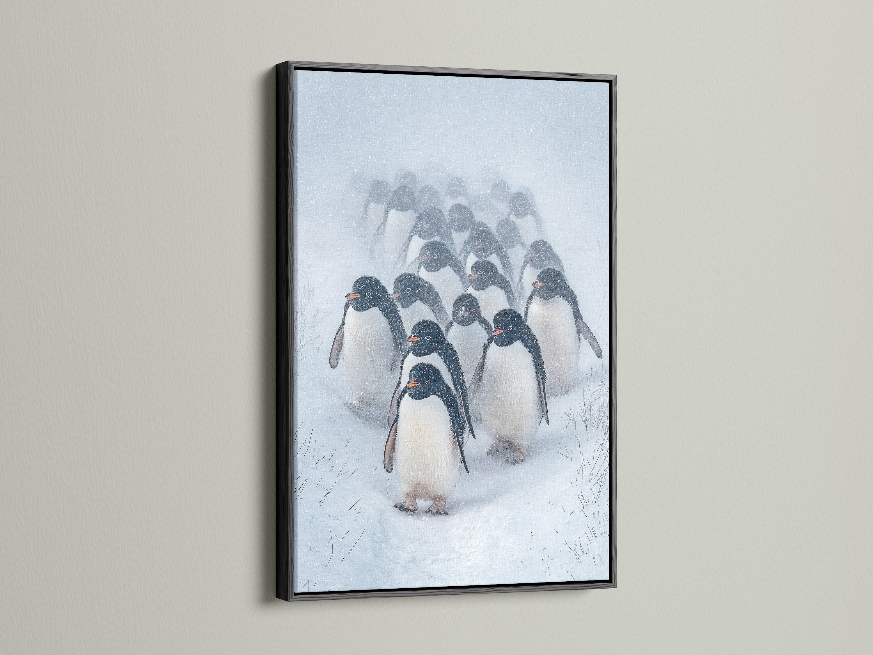 Black frame showcasing the Penguin Parade artwork. This animal wall art is ideal for a contemporary space. The black frame highlights the monochrome print of winter wildlife.