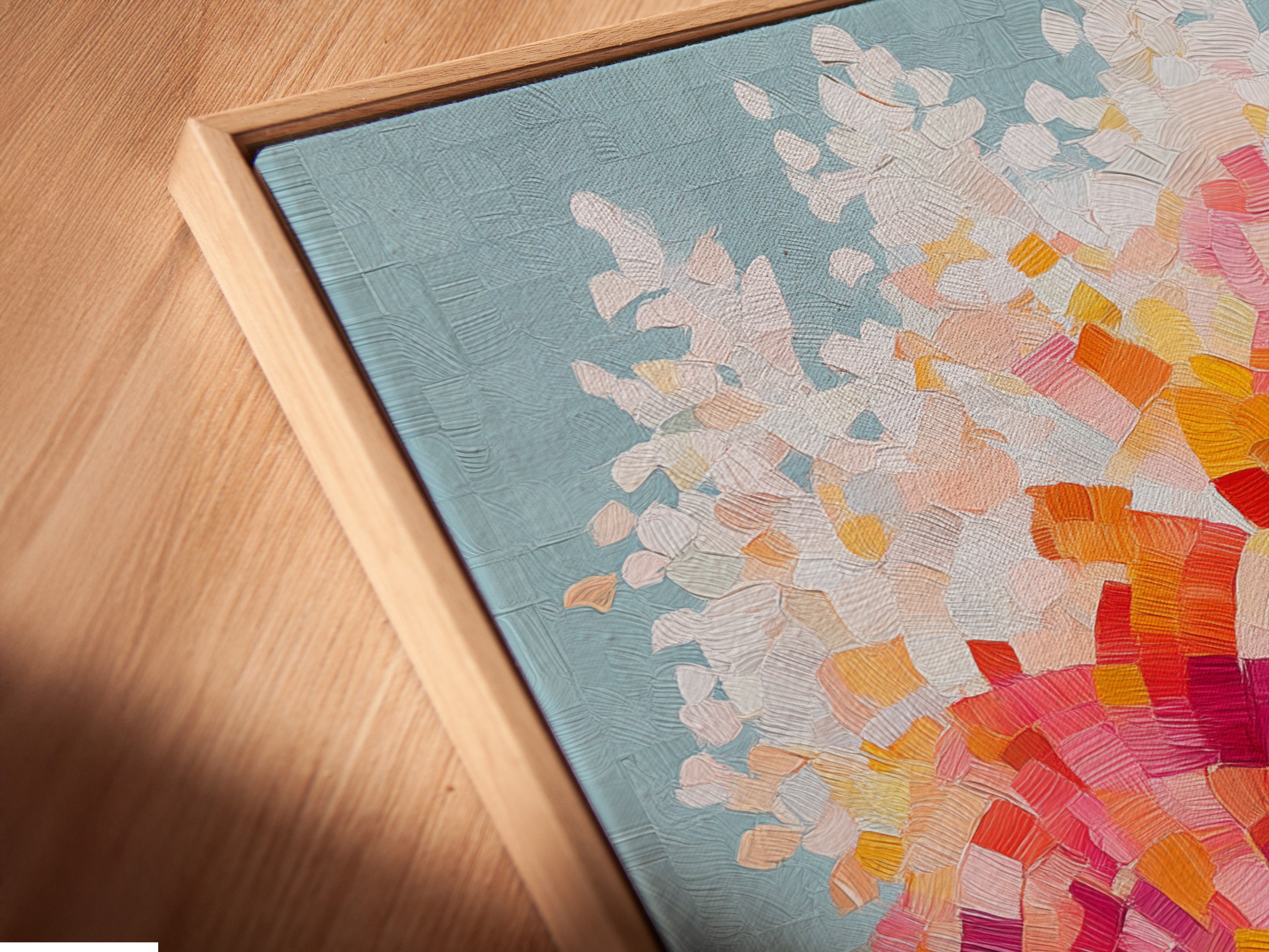 A close-up angled view shows a canvas print in a floating frame. The colorful tree artwork appears to hover. This mosaic wall art is modern and stylish. The abstract tree print adds depth and dimension. It's perfect for a contemporary art collection.