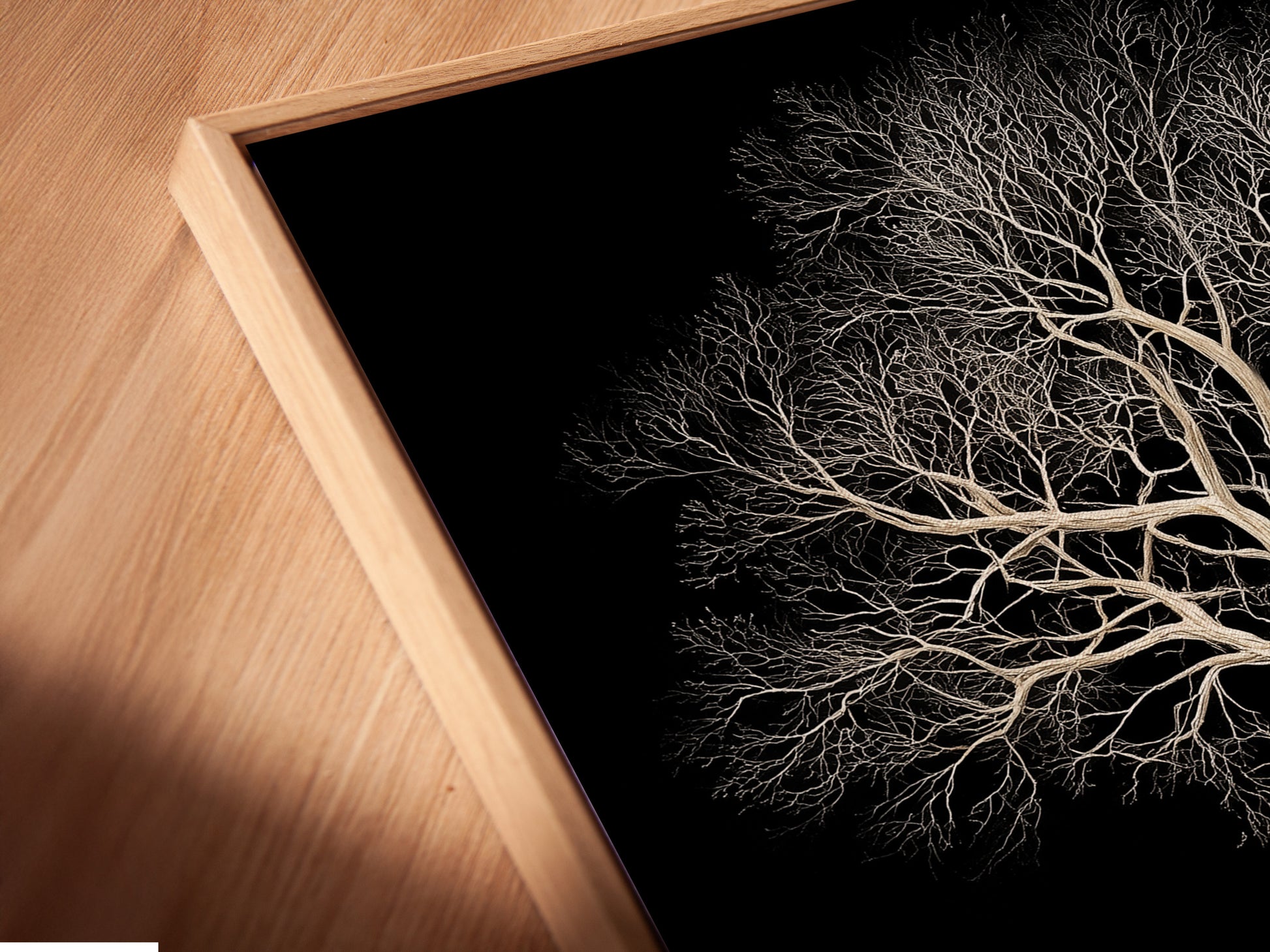 Close up of Tree of Life canvas print in a floating frame. The floating frame enhances the artwork's contemporary feel. This black and gold wall art adds depth and dimension. Perfect for modern interiors. A nature inspired artwork.