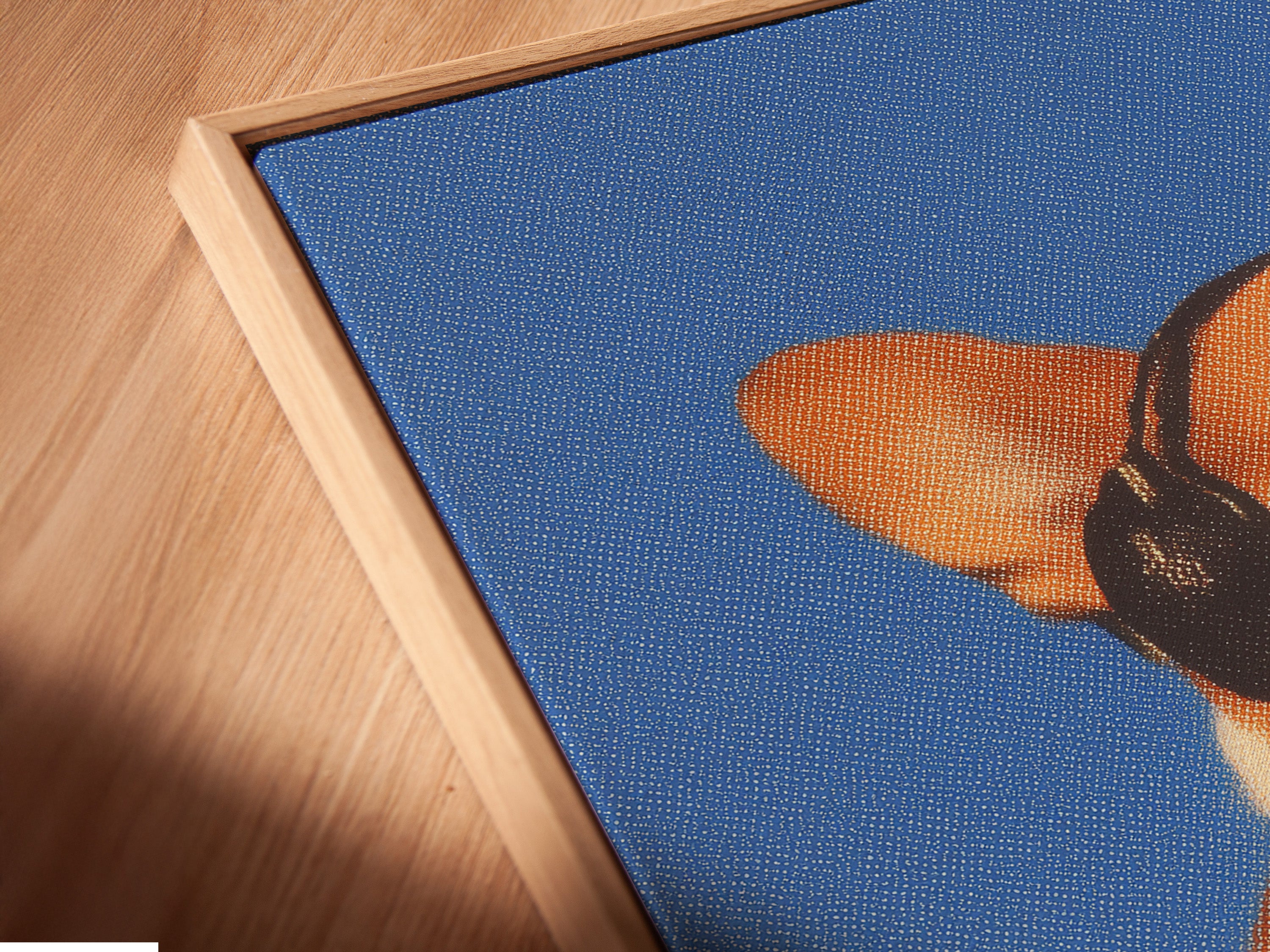 Angled close up of a Corgi Music Artwork Print in floating frame. Dog listening to headphones canvas wall art. A blue pet portrait for office wall decor. Ideal for dog lovers seeking unique wall art. Appreciate a touch of whimsy in your home.