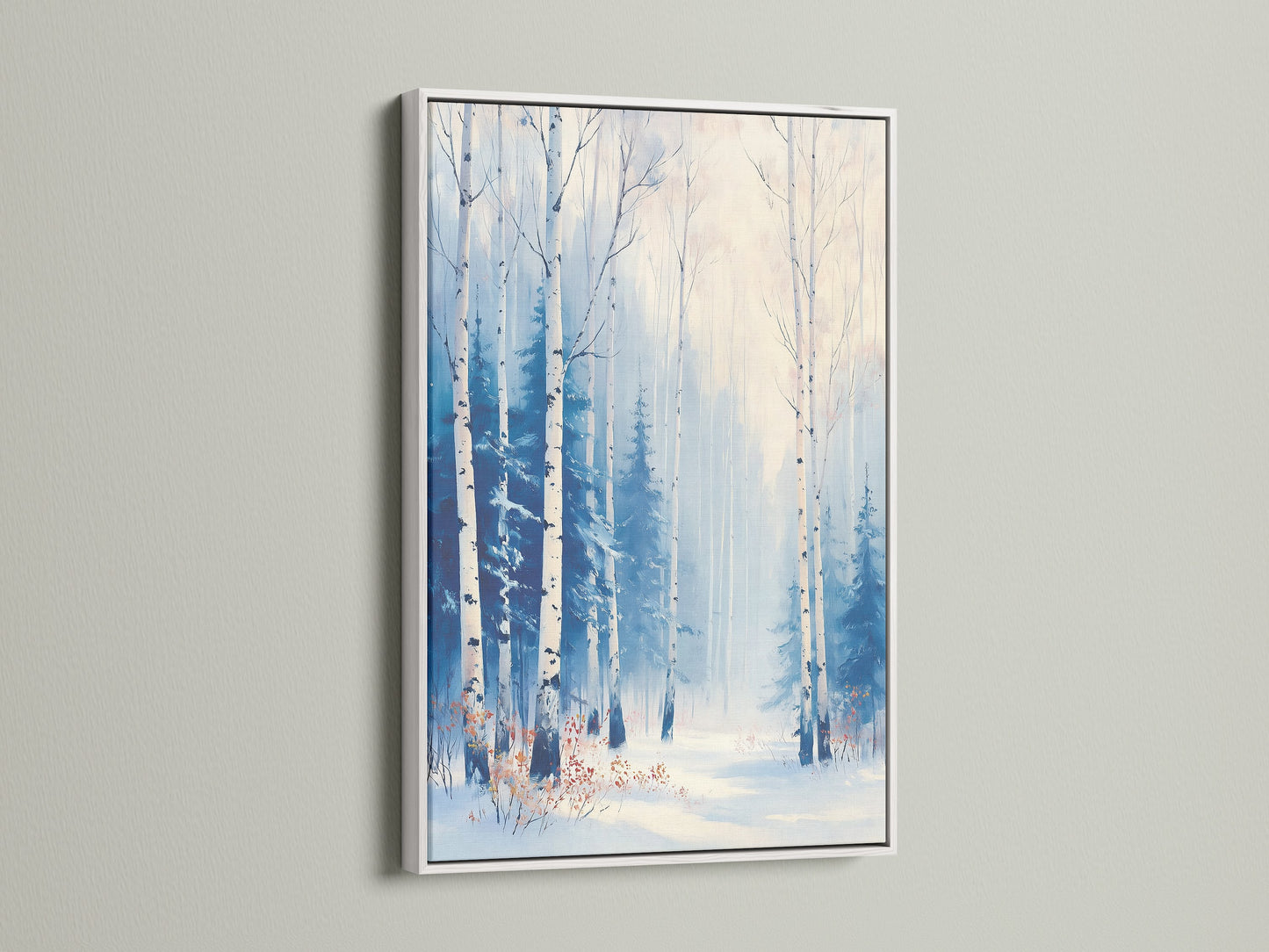 A winter forest artwork is displayed in a white frame. This birch tree print adds a touch of elegance. Ideal for scandinavian decor. This nature canvas art brings a wintery feel.
