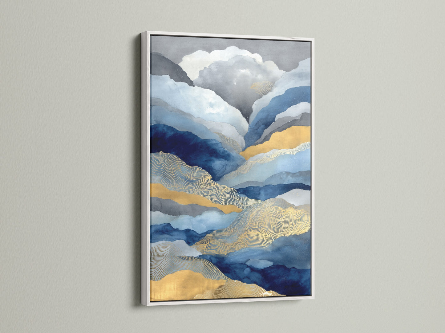 White frame enhancing blue and gold abstract mountain artwork. The landscape canvas adds modern nature to any room. This artwork is ideal for living rooms bedrooms offices lobbies studios clinics and spas.