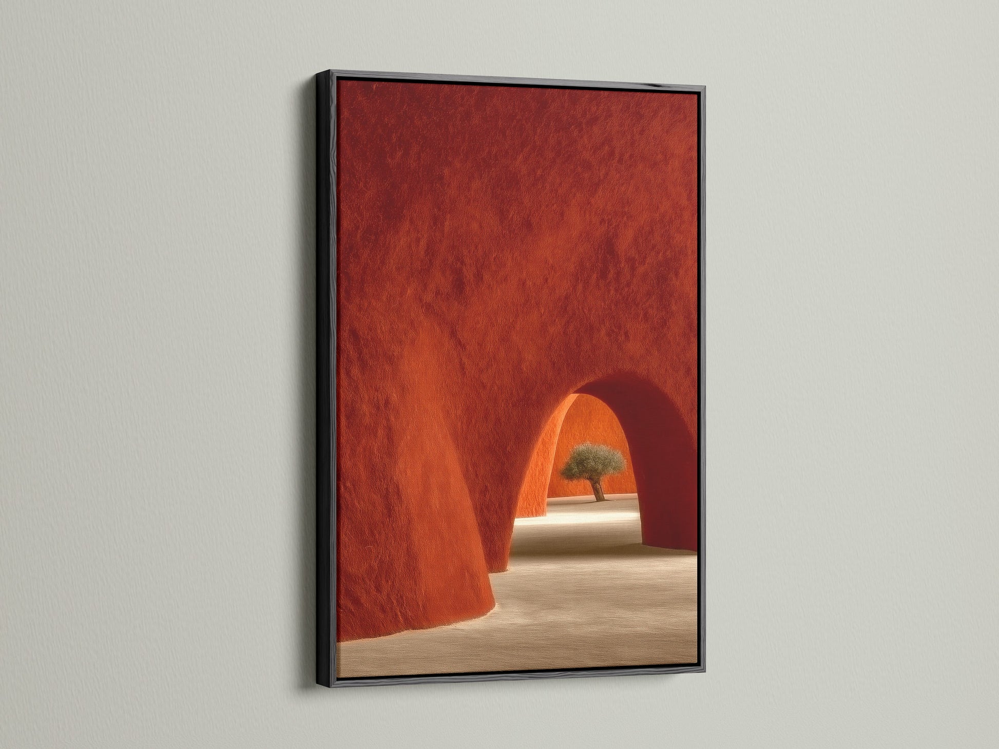 Black frame featuring Desert Architecture Canvas Artwork. The artwork showcases terracotta adobe arches. It is ideal Southwestern minimalist decor for the bedroom. The black frame adds a bold touch to this art.