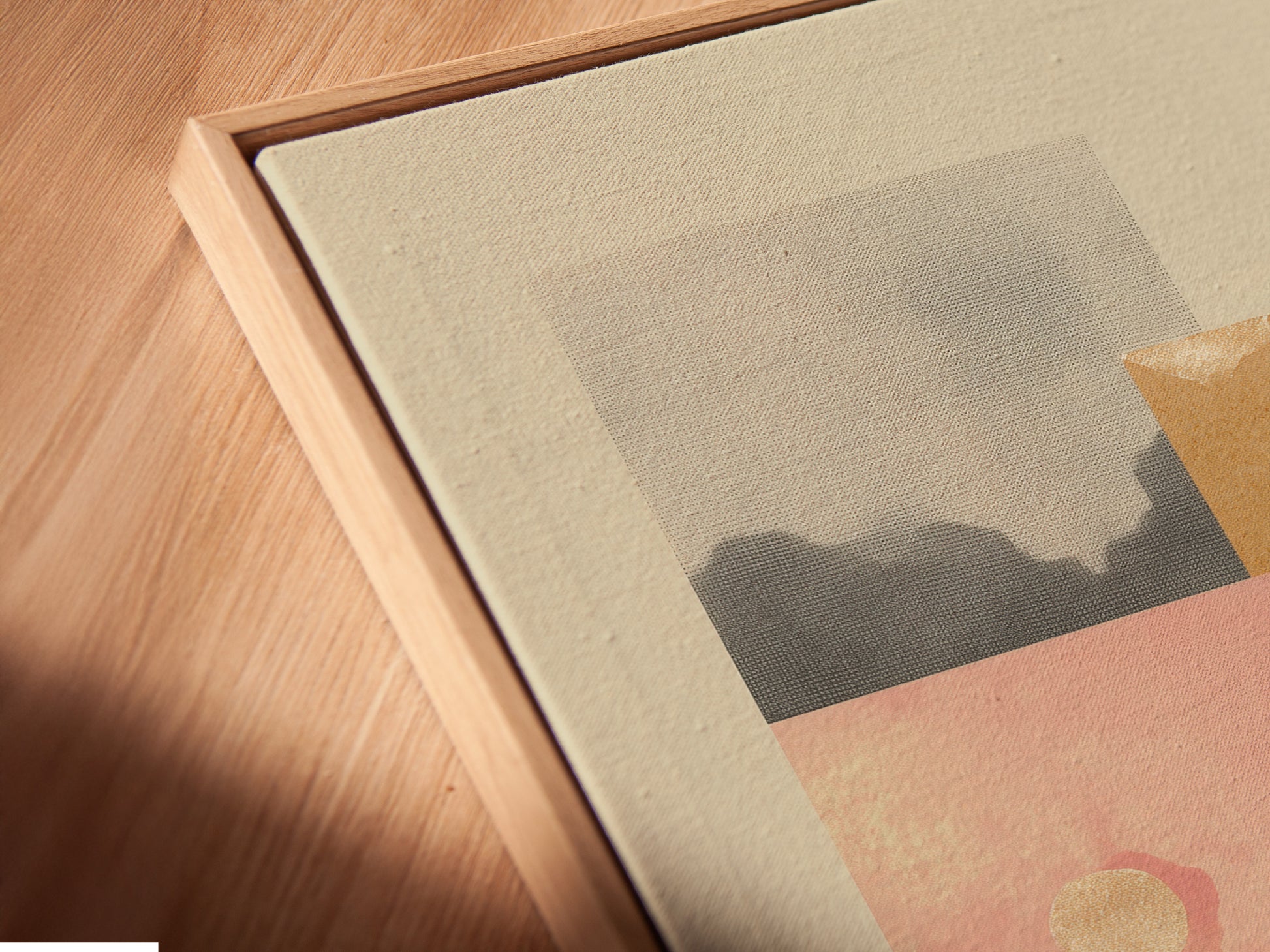 A close-up of a canvas print shows a floating frame. The angled view highlights frame detail. This modern framing style enhances artwork. It gives the art a sophisticated look. The floating effect adds depth. It makes the piece stand out.