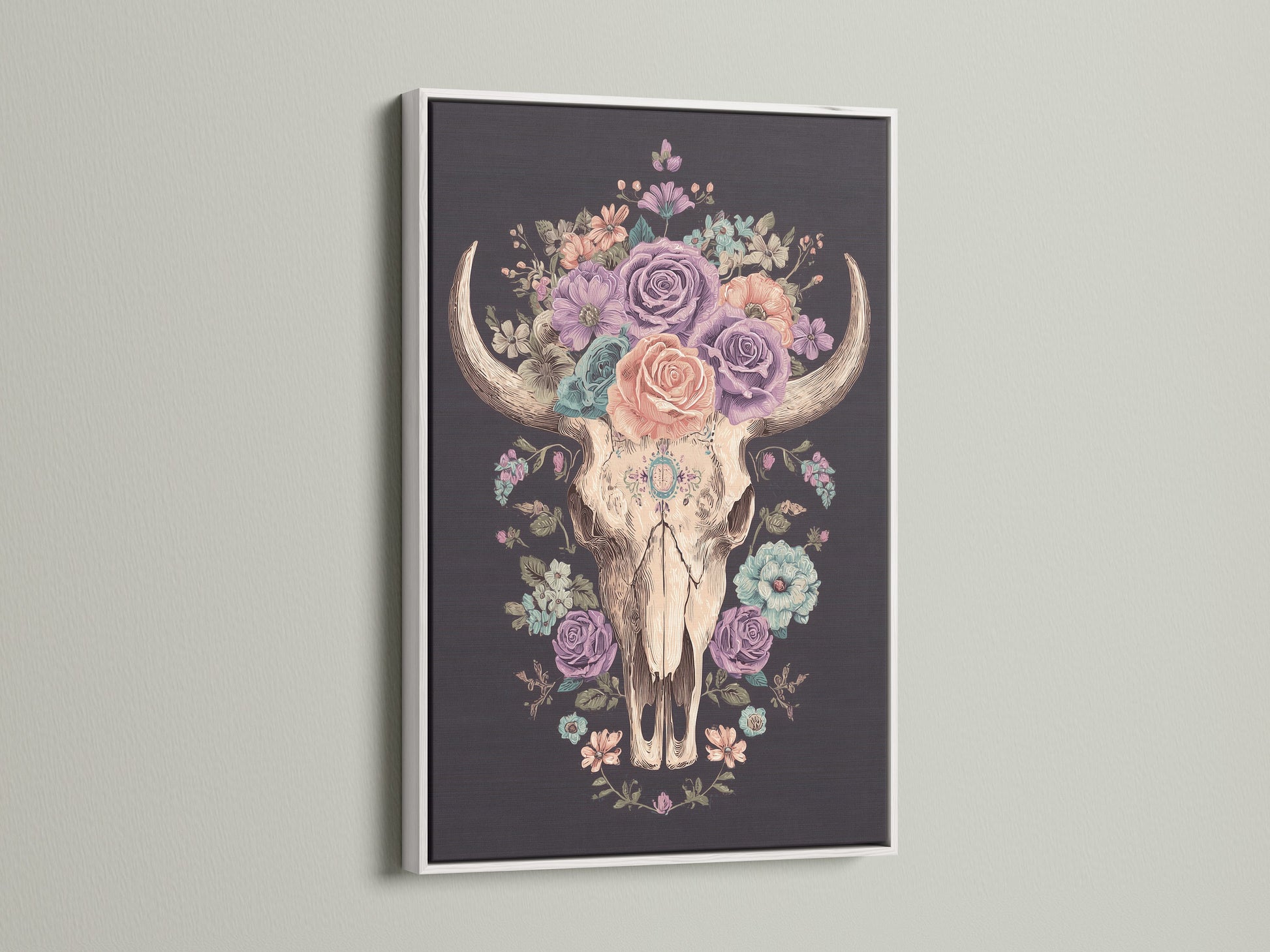 Artwork of a floral bull skull in a white frame. The art print features a skull adorned with colorful roses. This artwork is framed in a clean white frame. The white frame enhances the artwork. Perfect wall art for any space.