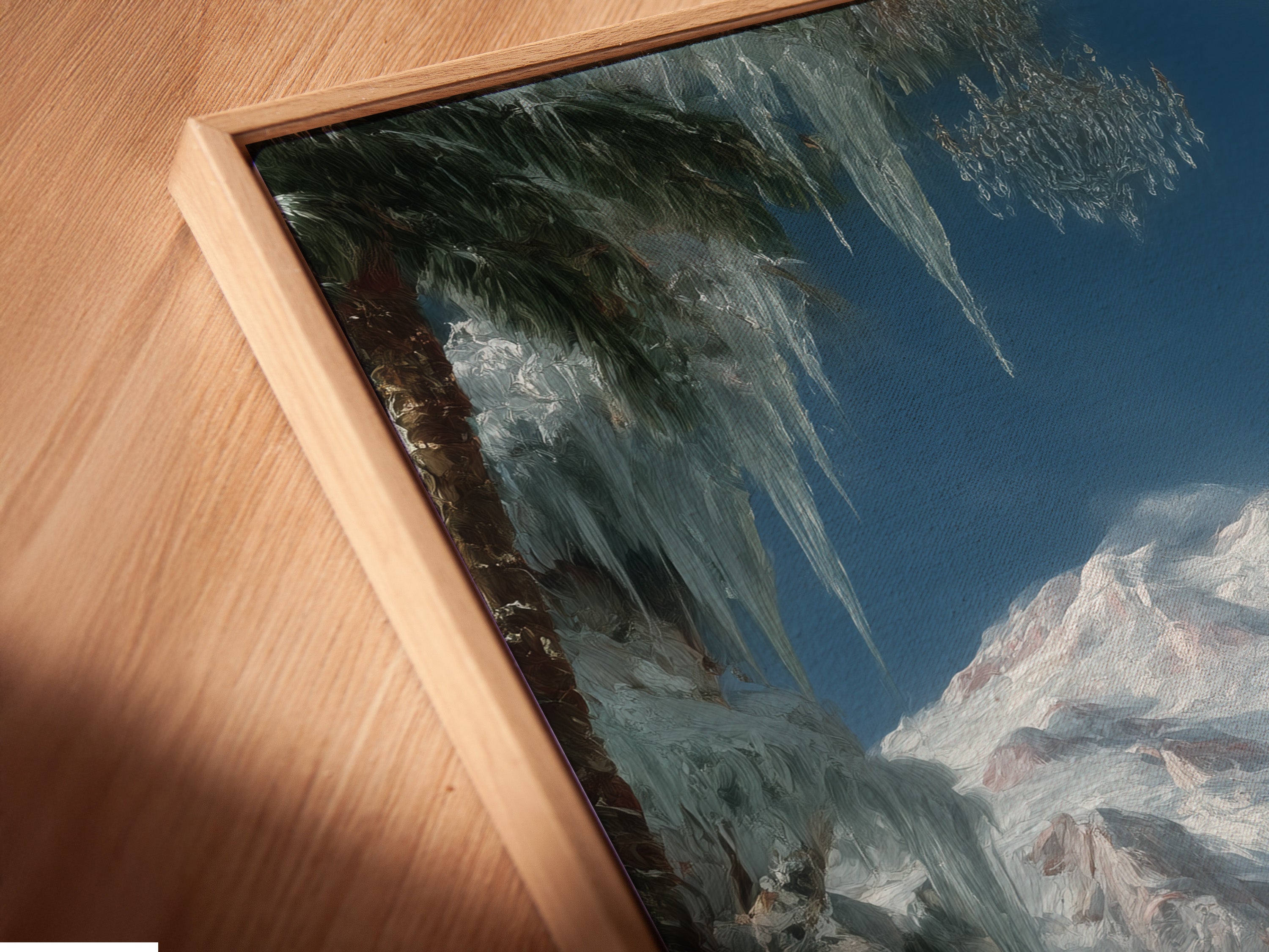 A close-up of a Winter Cabin canvas print in a floating frame. The artwork features a snowy mountain landscape. The floating frame enhances the art's contemporary appeal. Perfect for modern interiors.