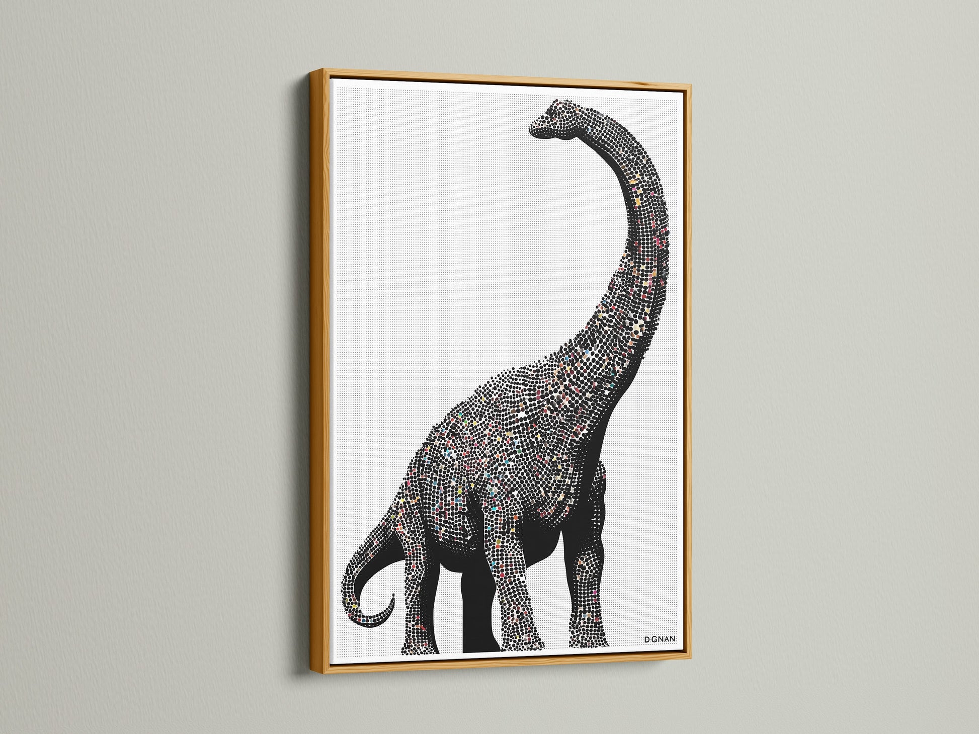 Dinosaur wall art featuring a minimalist brontosaurus canvas print. It is perfect modern nursery decor for a kids room. The artwork has a gold frame. This prehistoric art is great for studios.