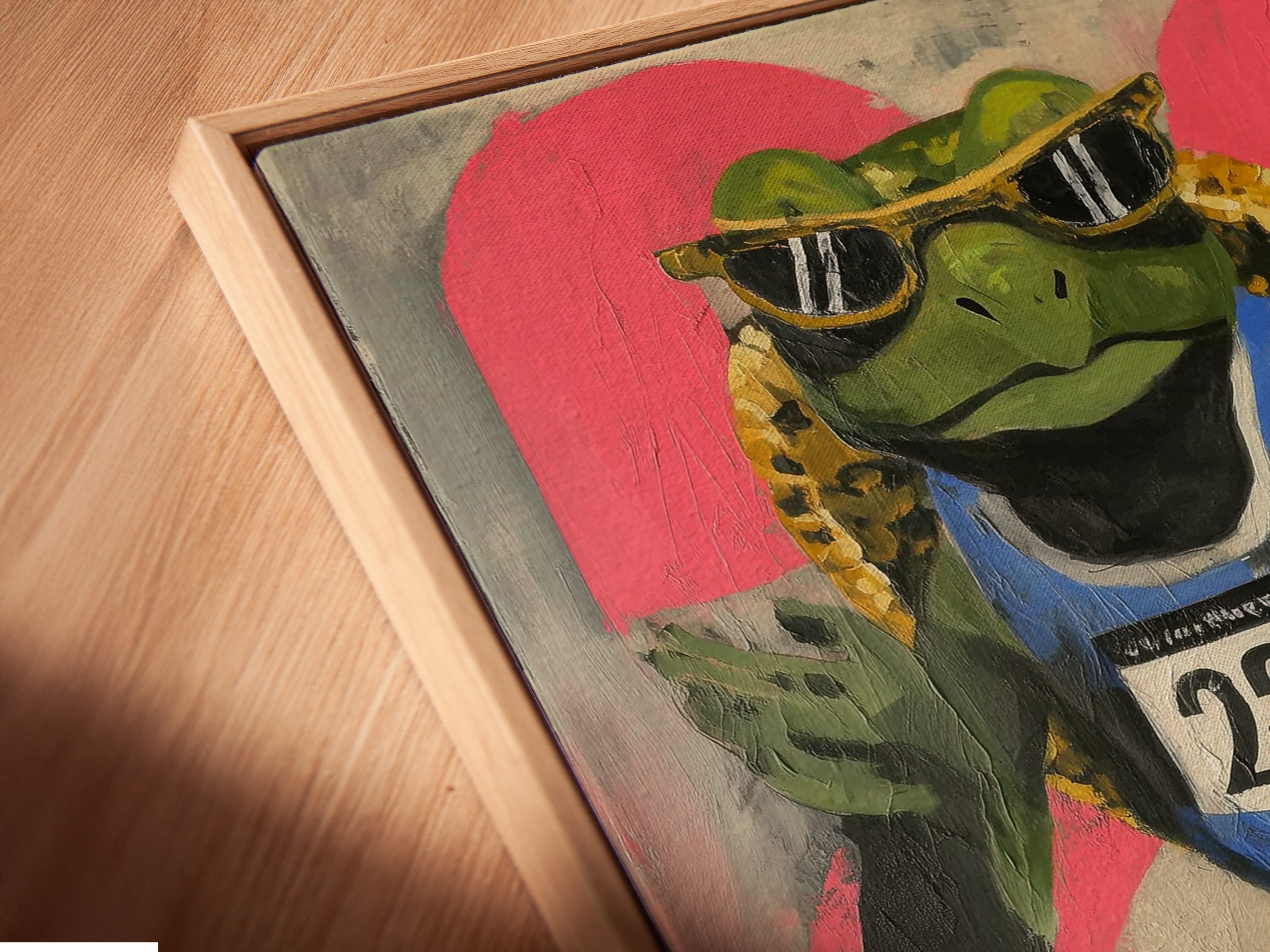 Angled close up of a canvas print in a floating frame. The frog runner artwork features graffiti style art. It adds an urban touch to any space. Ideal for teen room decor or fitness motivation. This retro sports art is perfect for boutique art studios lobbies and sports-themed rooms.