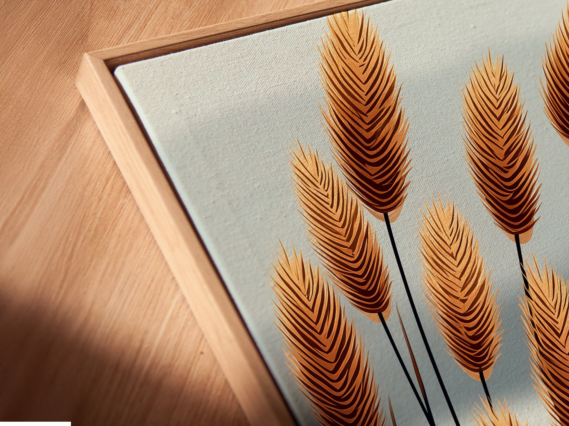 A close-up angled view of a canvas print in a floating frame. The pampas grass artwork is displayed. This showcases the modern framing option. This enhances minimalist art and boho wall decor in any interior setting.