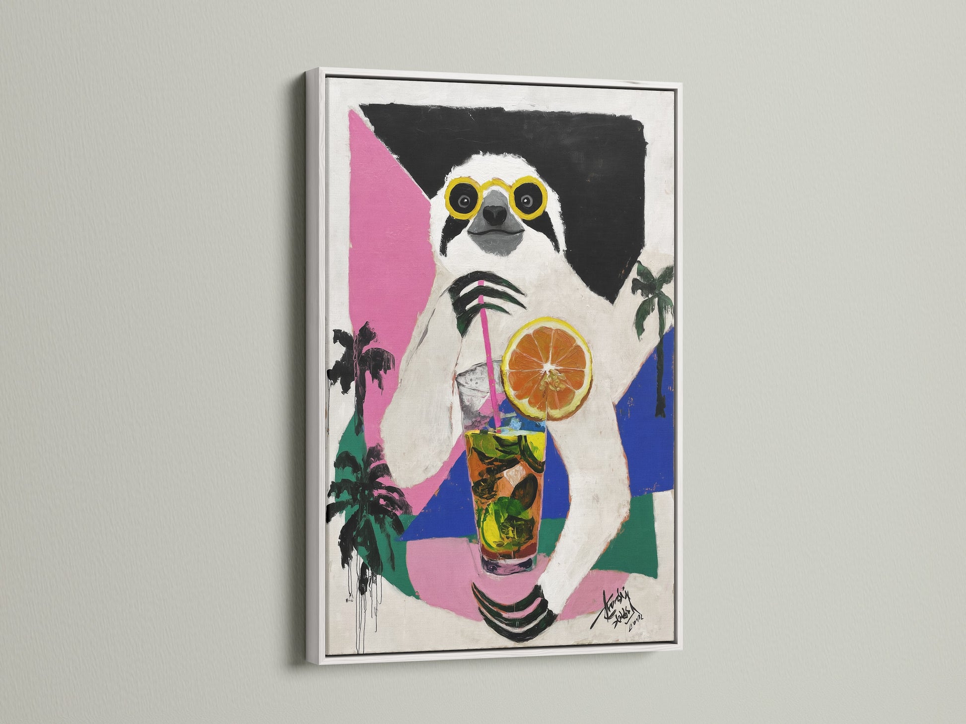 Sloth Cocktail artwork in a white frame. This tropical animal wall art brings a fresh vibrant feel. The white frame complements the artwork. It is perfect for adding a touch of humor and color to your space.