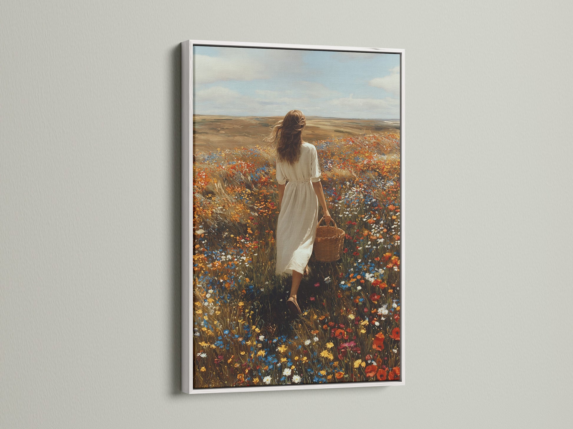 White frame artwork displayed in a modern home. The artwork shows a woman in a white dress. She's walking through a colorful field of flowers. The white frame provides a clean aesthetic. It enhances the artwork's beauty. Explore framed artwork for your home. Elevate your interior with stylish art.