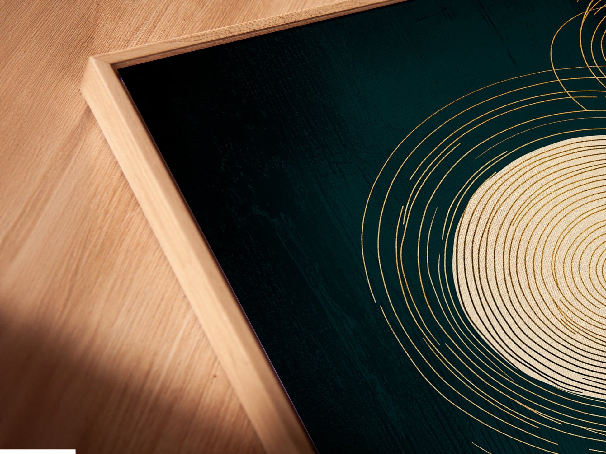 Close-up of a canvas print in a floating frame. The abstract geometric artwork features emerald green and gold. The floating frame adds depth. It's ideal for a contemporary art collection.