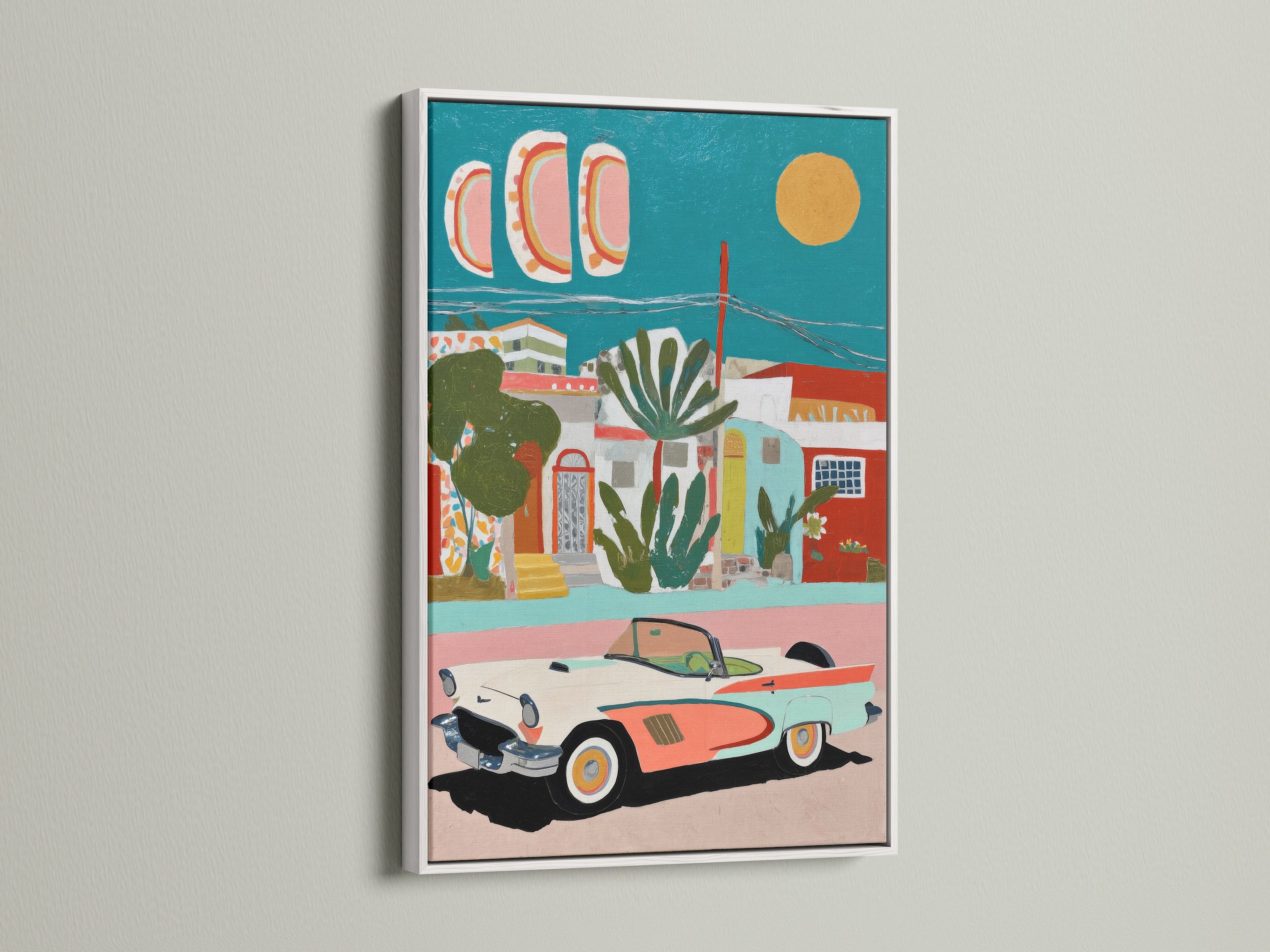 Coastal wall art featuring a vintage car in a Mediterranean village. This artwork is framed in white. The white frame enhances the coastal and tropical style. The teal and coral colors bring a fresh vibrant feel to any space. Perfect for bedroom wall art.
