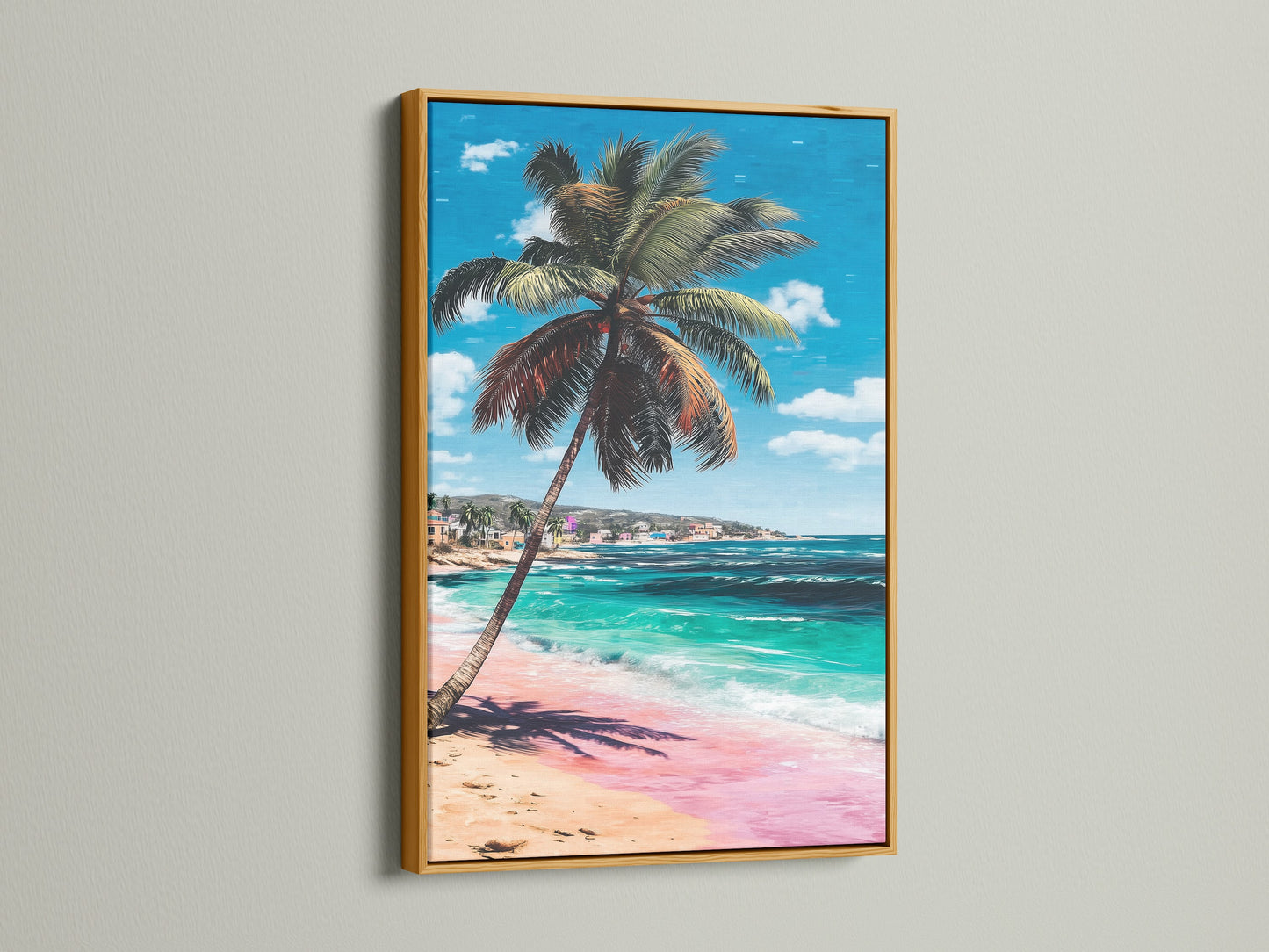 Tropical beach artwork presented in a gold frame. This ocean wall art features a palm tree pink sand and turquoise water. It adds a touch of elegance to coastal or tropical themed home decor.