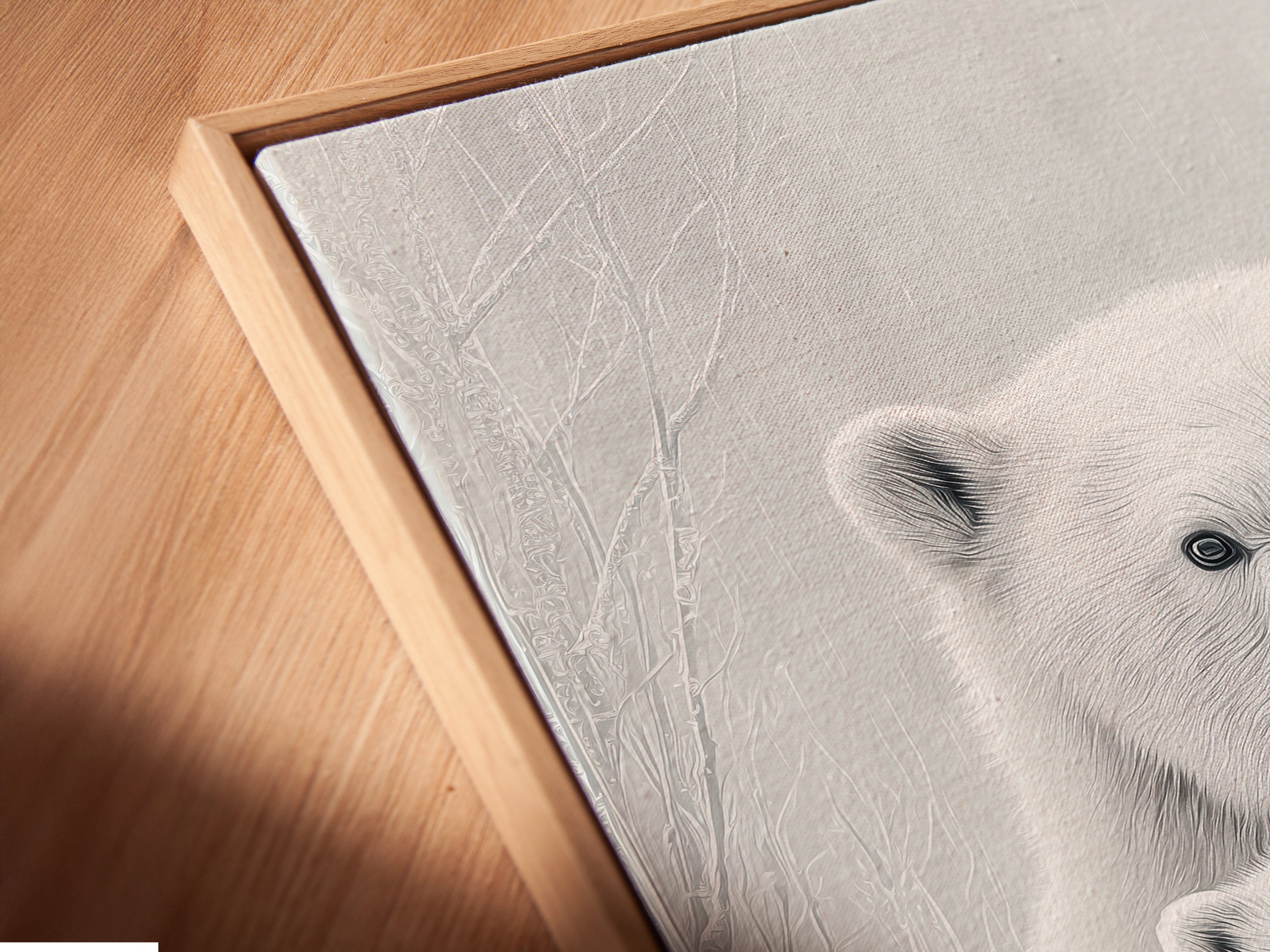 A close up angled view shows a canvas print in a floating frame. The monochrome polar bear artwork appears to float. This enhances the contemporary style of this wildlife wall art.