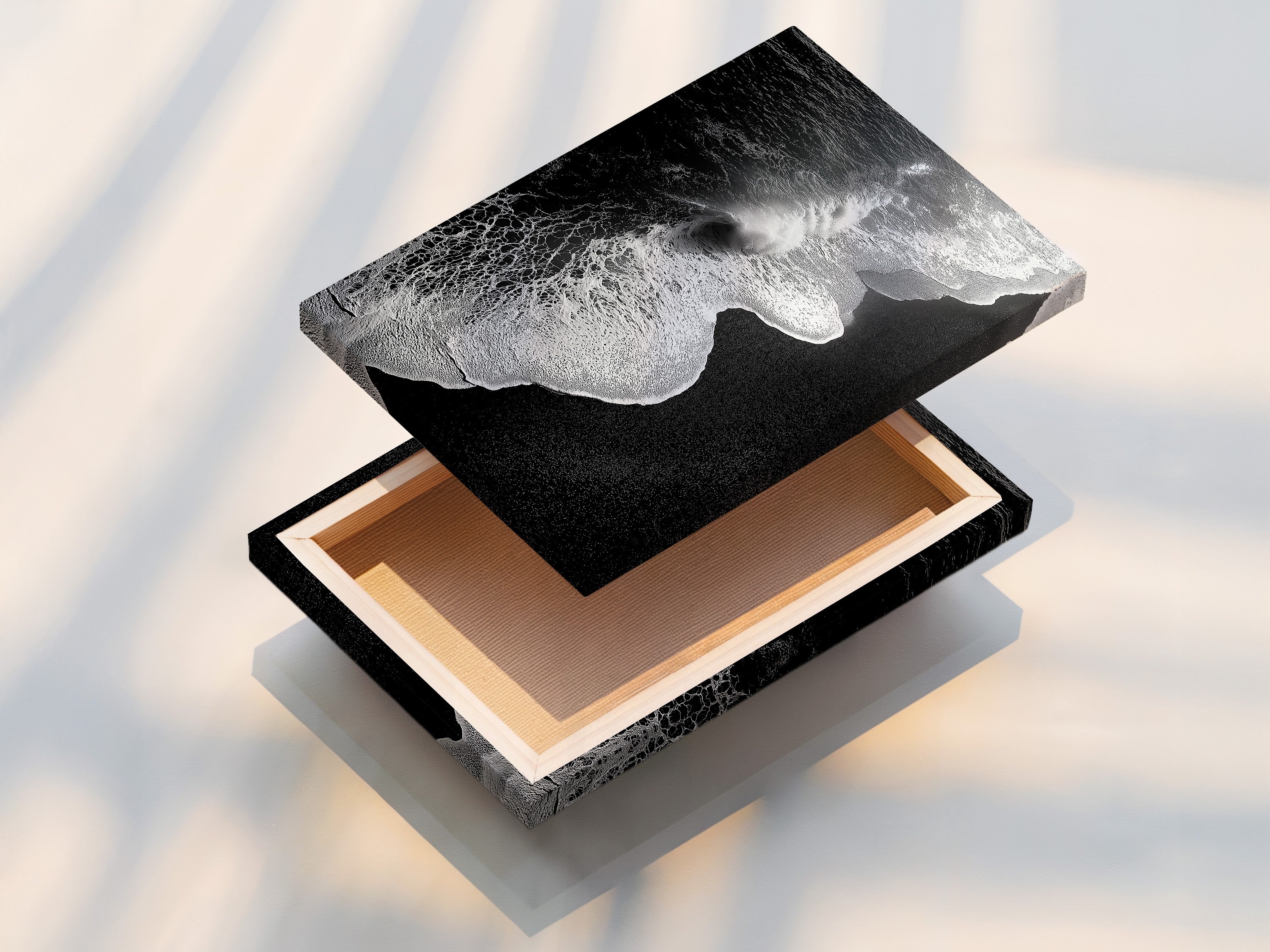 A stretched canvas print displays a captivating black and white ocean wave artwork. This piece is perfect for creating a focal point. It is perfect for minimalist decor. This beach canvas print brings coastal charm to any room. Ideal for living room wall art and office art. Add a touch of modern coastal art to your space.