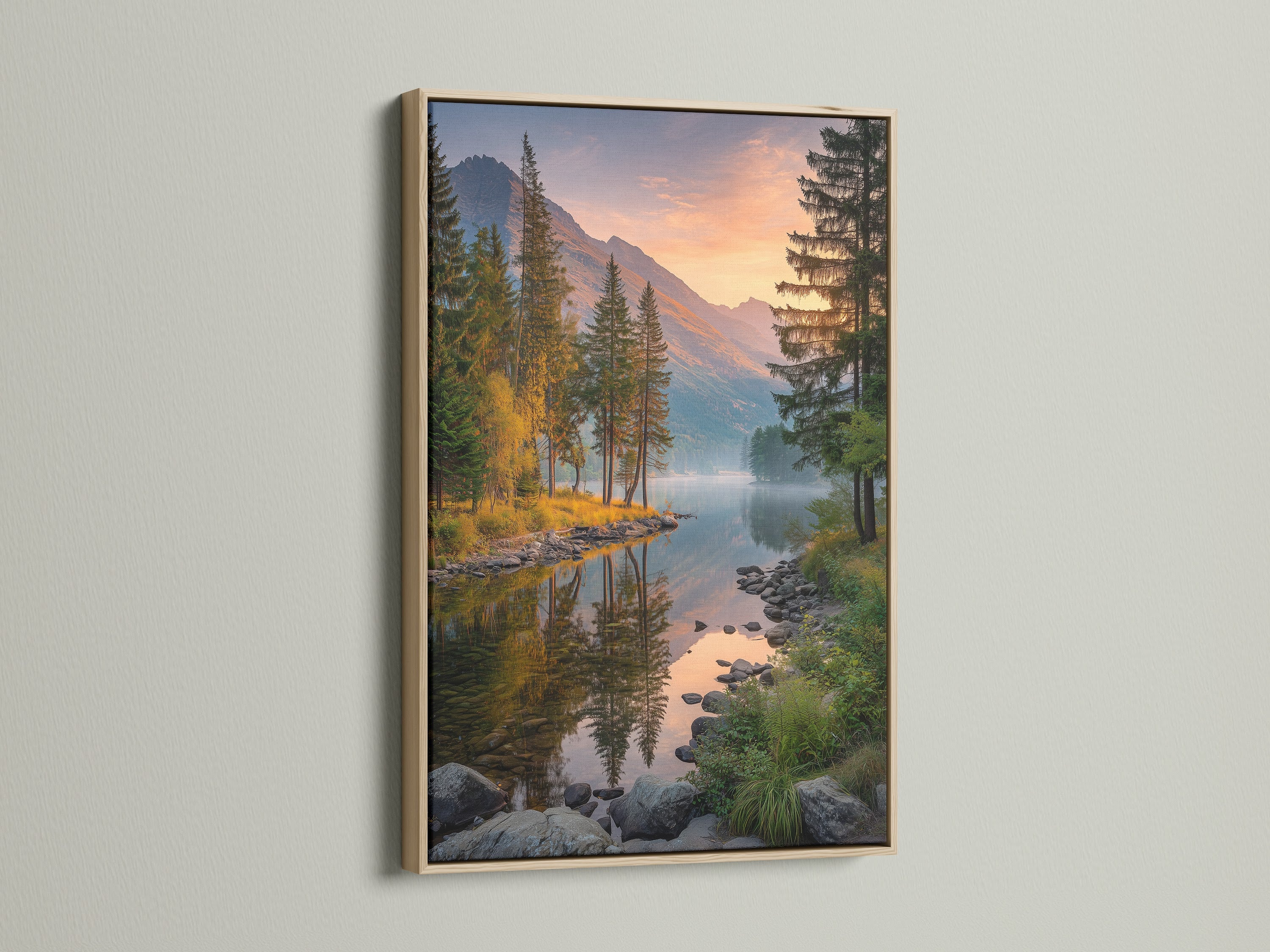Mountain lake canvas art in an oak frame. The landscape wall art captures a tranquil scene with a mirror-like lake and towering mountains. This nature print is perfect for adding a rustic or farmhouse touch to your living room bedroom or cabin decor. A serene scenic print for nature lovers.