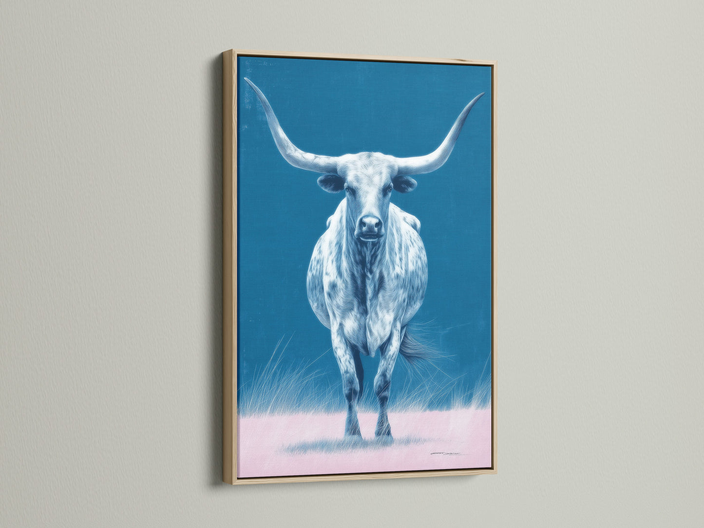 The longhorn bull artwork is showcased in an oak frame. The artwork is a western wall art piece. The blue and pink hues add a modern farmhouse touch. This bull canvas print is perfect for ranch decor.