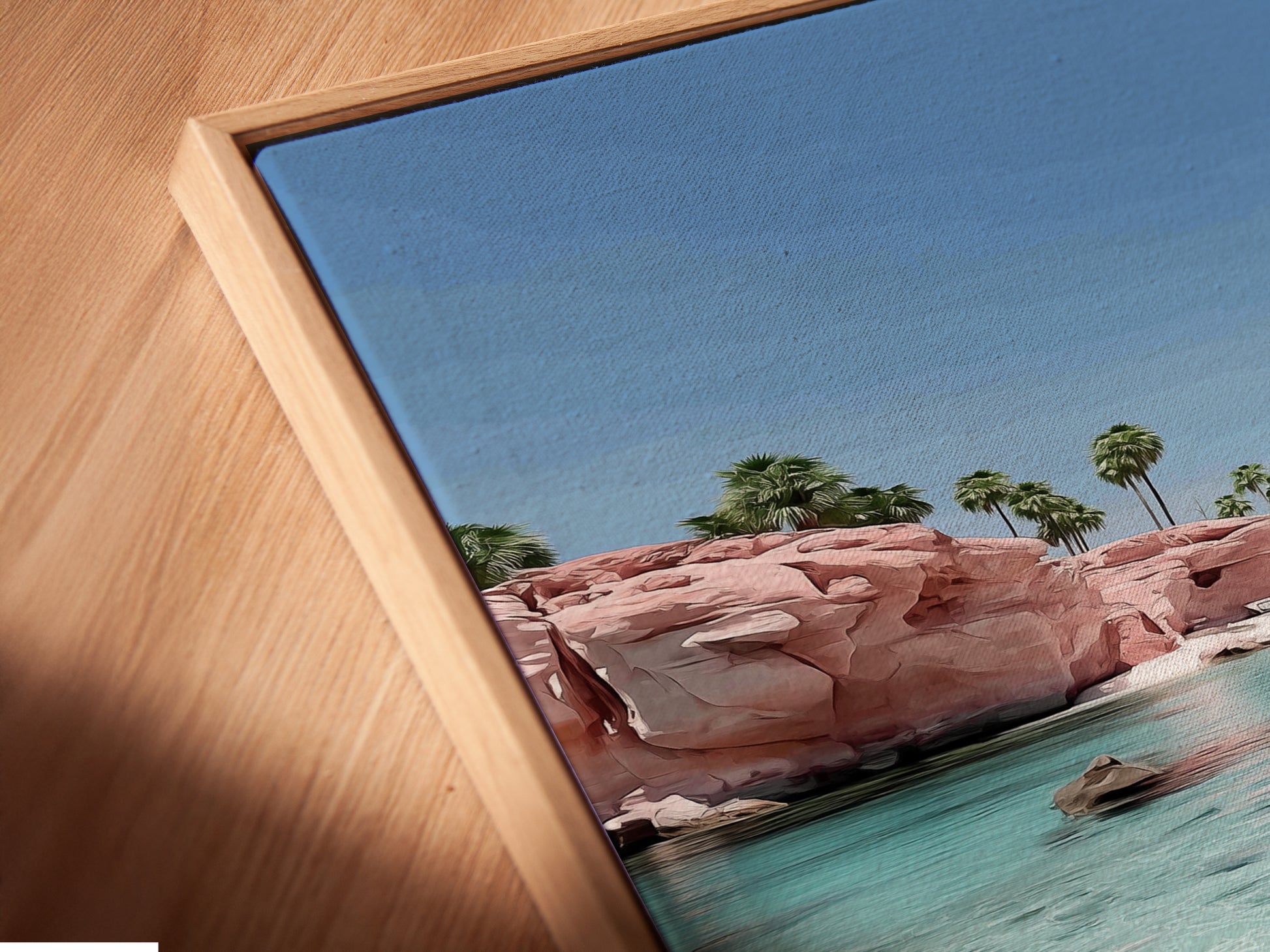 A close up of a canvas print. This canvas print features a pink sand beach in a floating frame. The floating frame gives the artwork a modern look. Perfect for a coastal or beach-themed room.