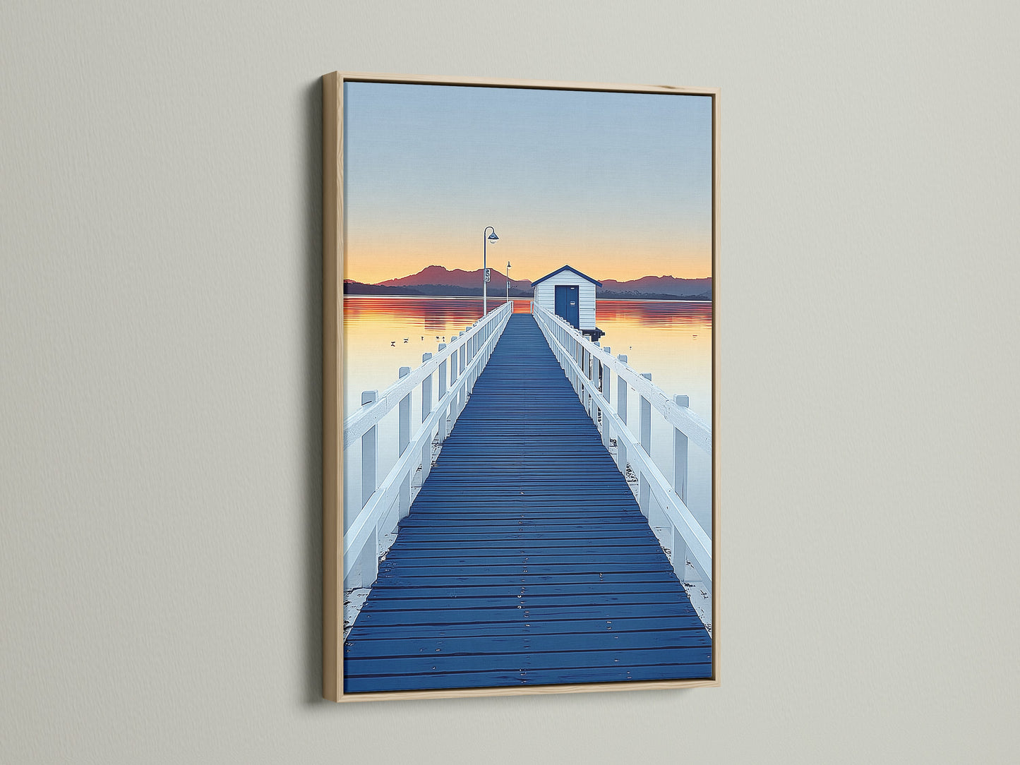 Elevate your space with dock sunset artwork. The artwork features a blue pier wall art print in an oak frame. The frame enhances the coastal scenery photography. This artwork adds a touch of nature to your home decor.