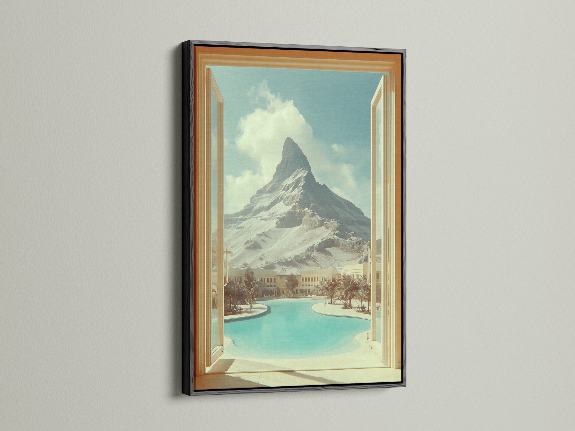 Black frame featuring mountain view artwork. This artwork creates an open window effect to a desert oasis. Ideal for living room wall art or studio decor. This travel scenery print adds vacation vibes to any space. Bring scenic artwork into your home.