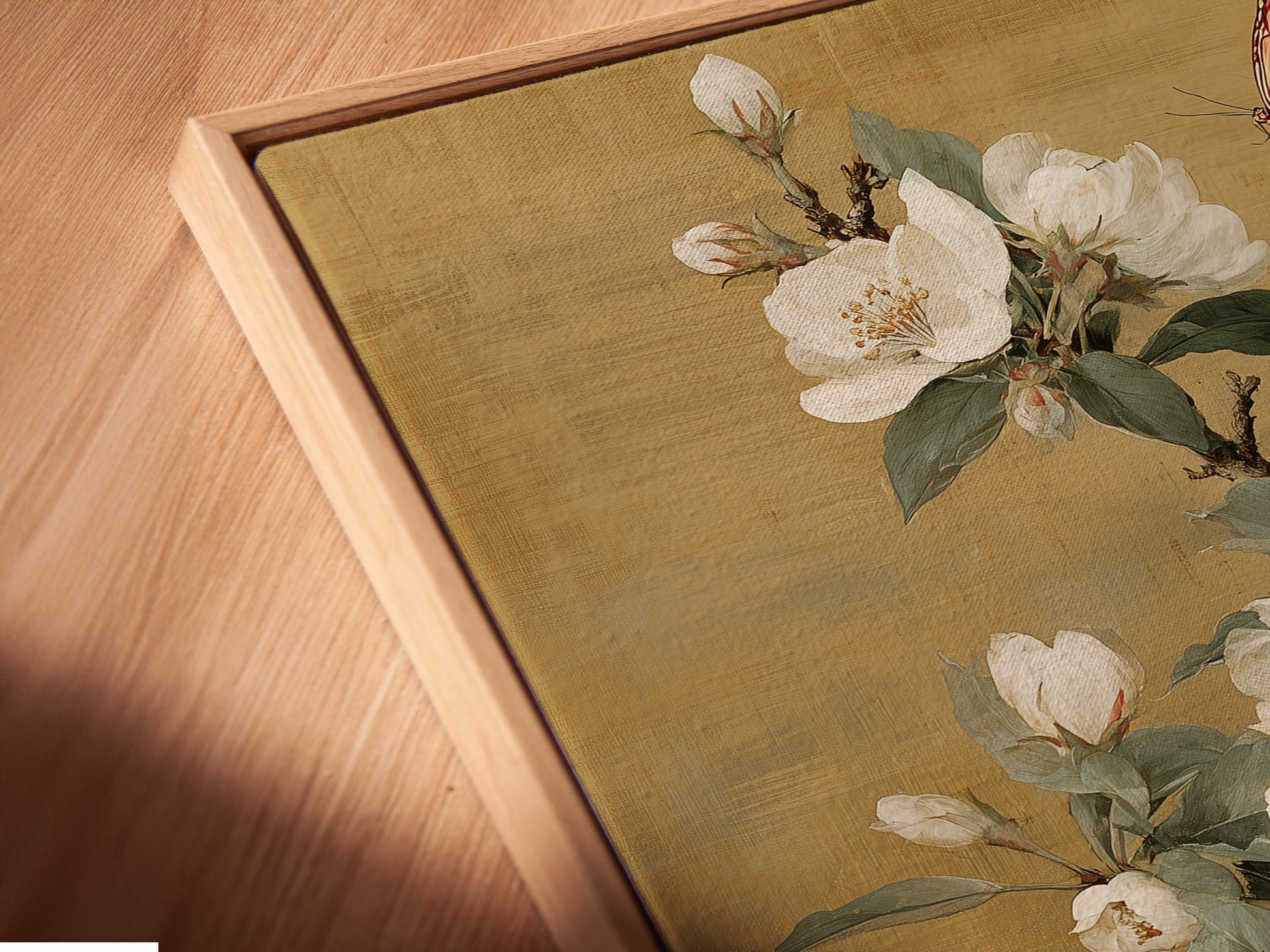 Close-up of a canvas print in a floating frame. This artwork features a vintage botanical design with white flowers. Perfect for adding a touch of elegance to your home decor. This botanical canvas art complements vintage farmhouse traditional or eclectic styles.