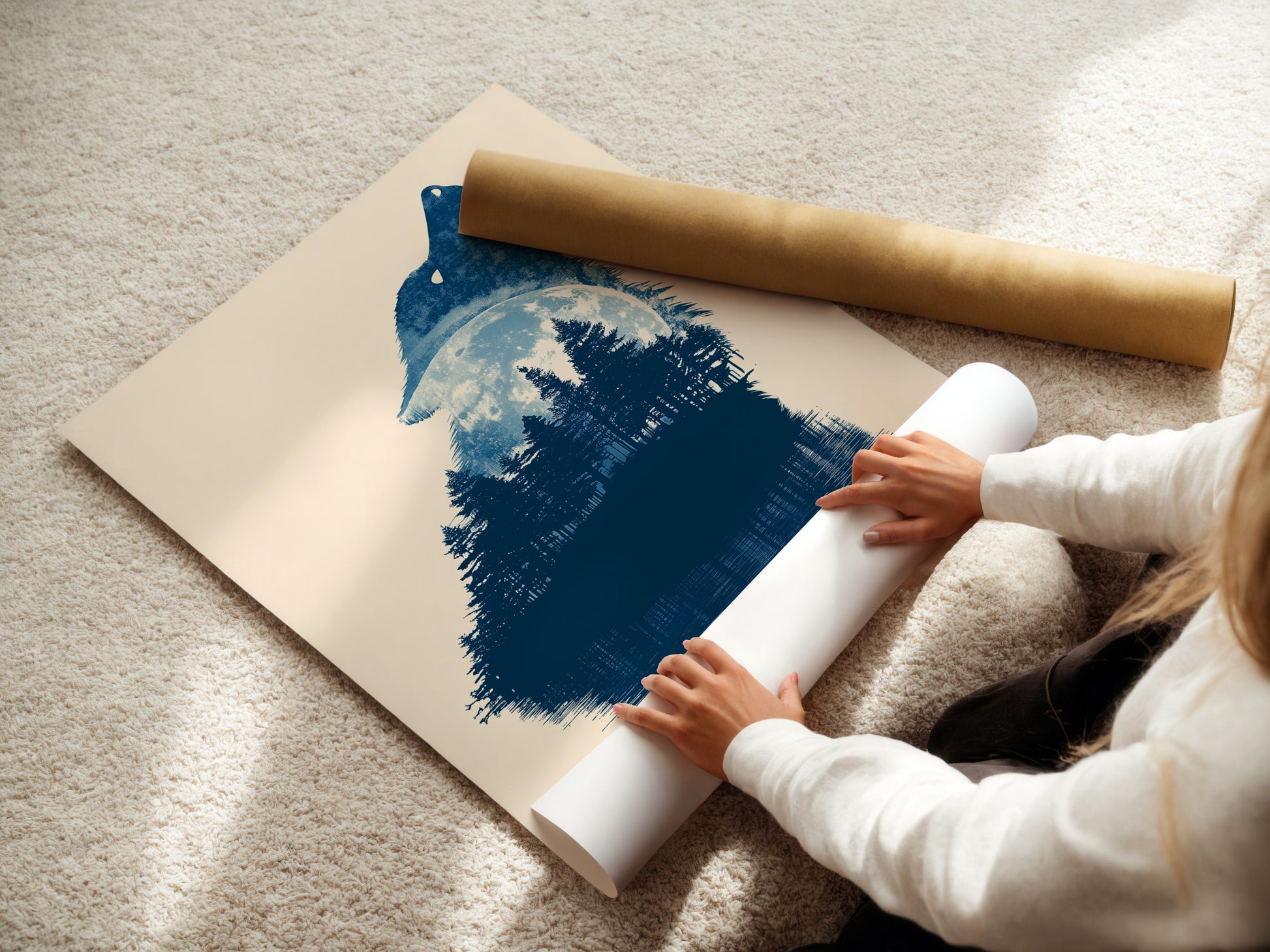 A woman is carefully rolling a fine art poster paper. The poster features a wolf silhouette in a forest with a moon. Perfect for rustic and primitive styles. A great choice for wildlife prints.