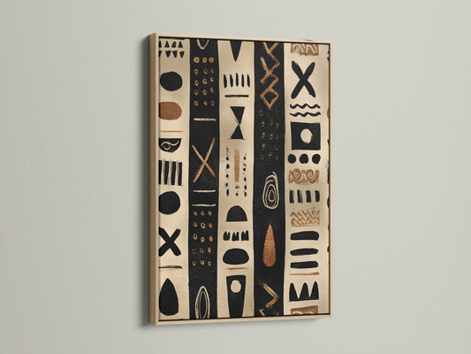 Artwork in an oak frame. The artwork has black and tan stripes with tribal inspired shapes. The artwork is hanging on a white wall. The light reflects off the glass. This artwork is perfect for modern minimalist homes.