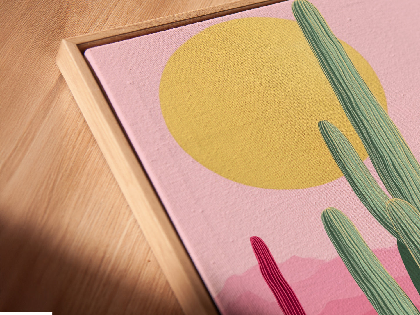 Close-up of canvas print in a floating frame. The Southwestern cactus artwork features pink and teal botanical prints. The floating frame enhances the desert wall art. Modern minimalist or boho aesthetics are complemented by this art.