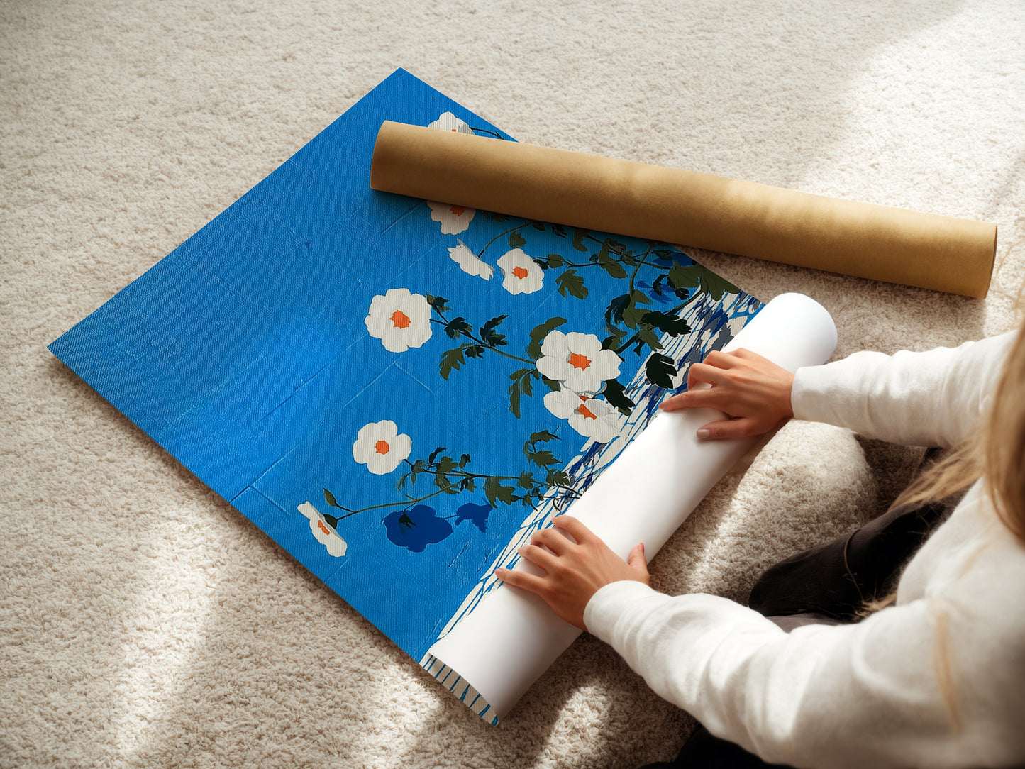 A woman is carefully rolling a fine art poster paper. The floral artwork poster features azure blue tones. The botanical print is perfect for creating modern wall decor. This fine art paper ensures quality.