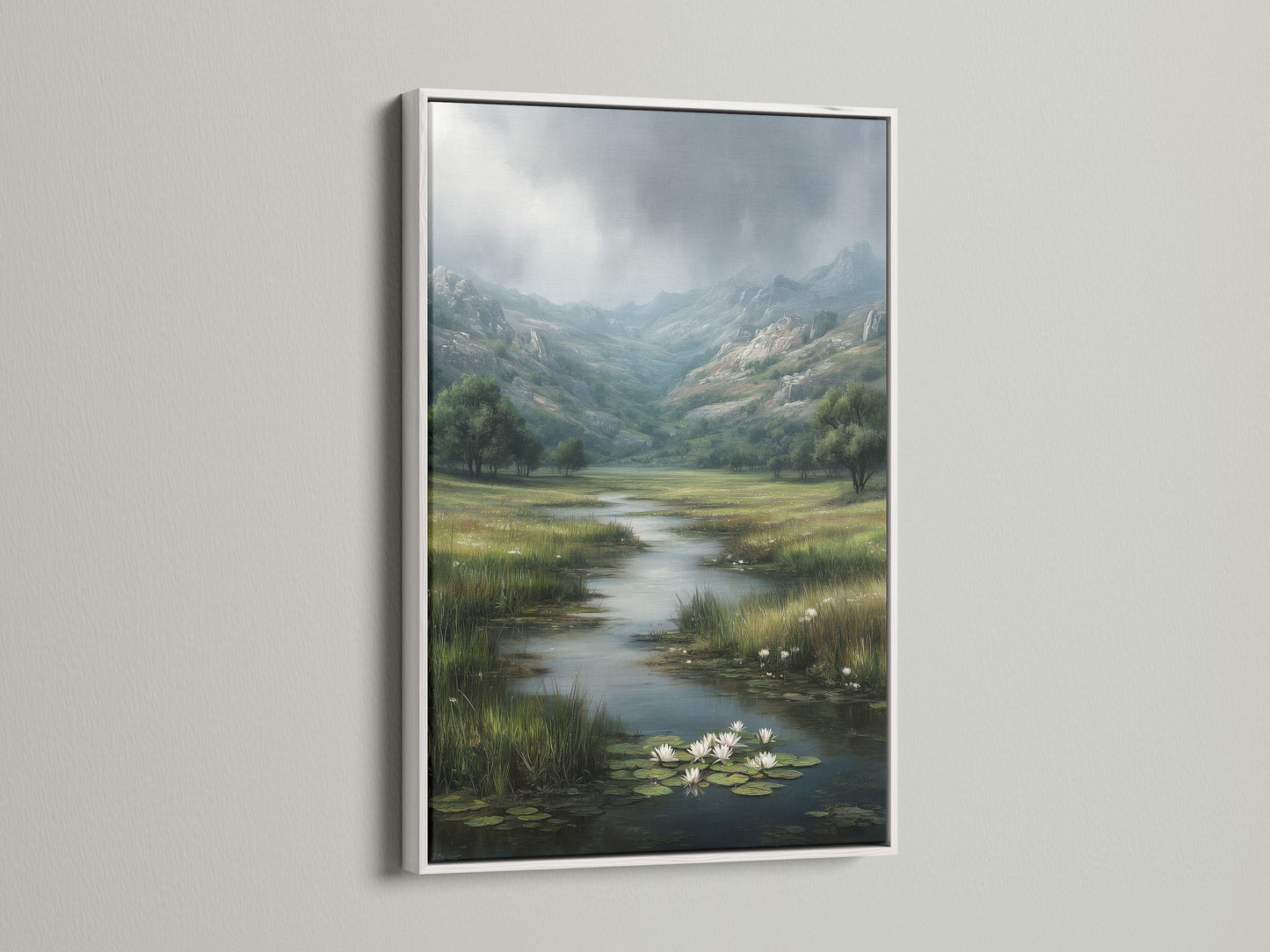 A white frame enhances a scenic landscape artwork. The art print depicts a river with water lilies in a valley. The white frame offers a clean and modern touch to the artwork. The light wall allows the art to stand out. It adds a fresh and airy feel to the space.