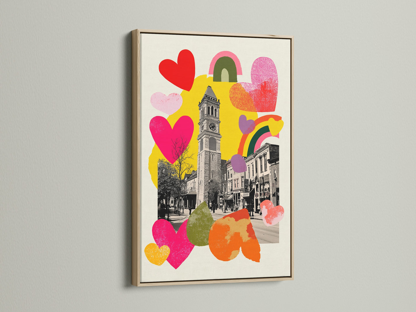 Artwork with an oak frame on a wall. The art features a clock tower. It also has colorful hearts and rainbows. The oak frame adds a touch of natural elegance to the artwork. Ideal for living rooms or offices. Explore our framed art collection now.