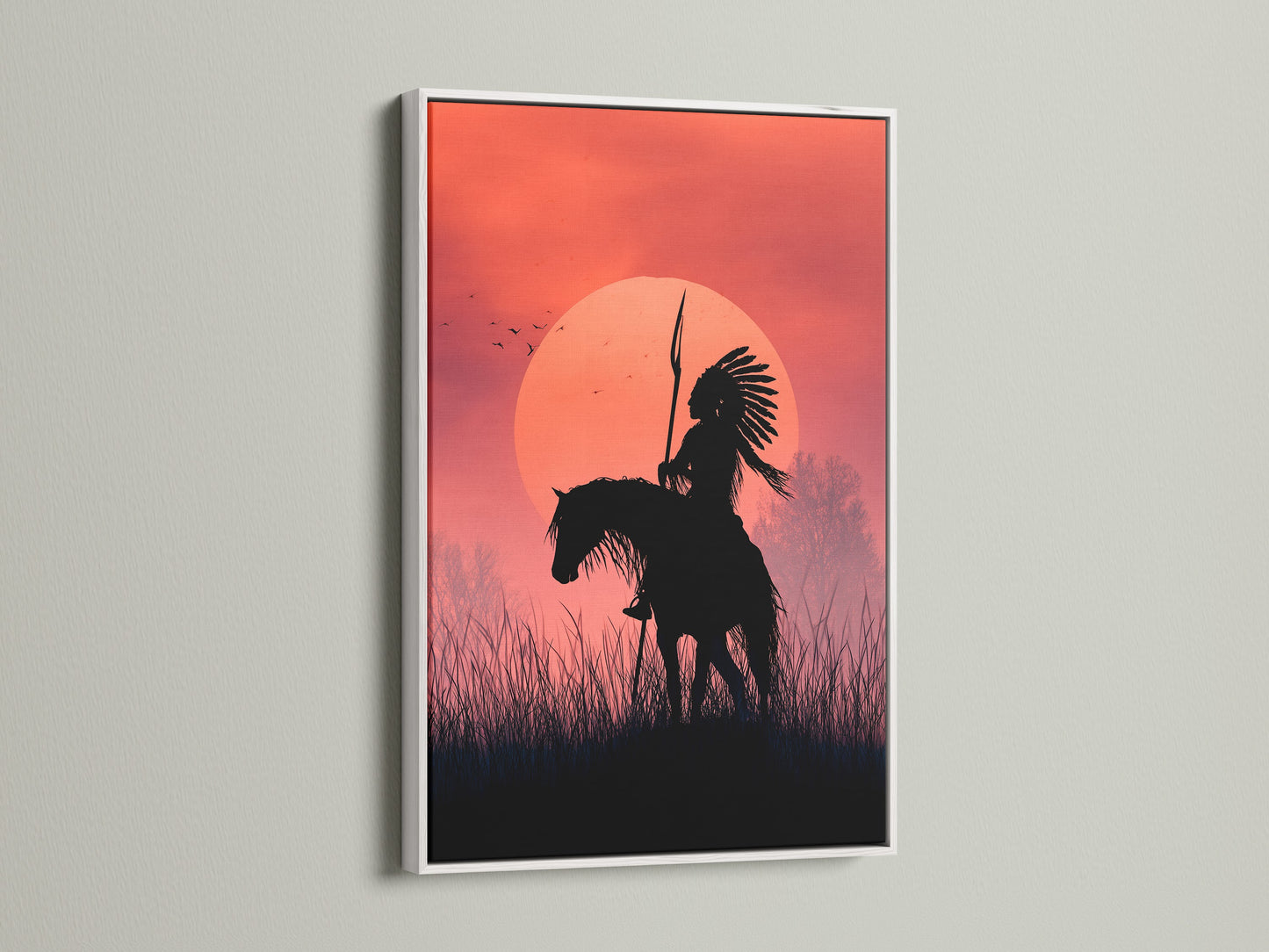 A stunning artwork of an indigenous person on horseback at sunset is displayed in a white frame. The white frame enhances the artwork. It brings a modern touch to any living space. Shop now and elevate your home decor.